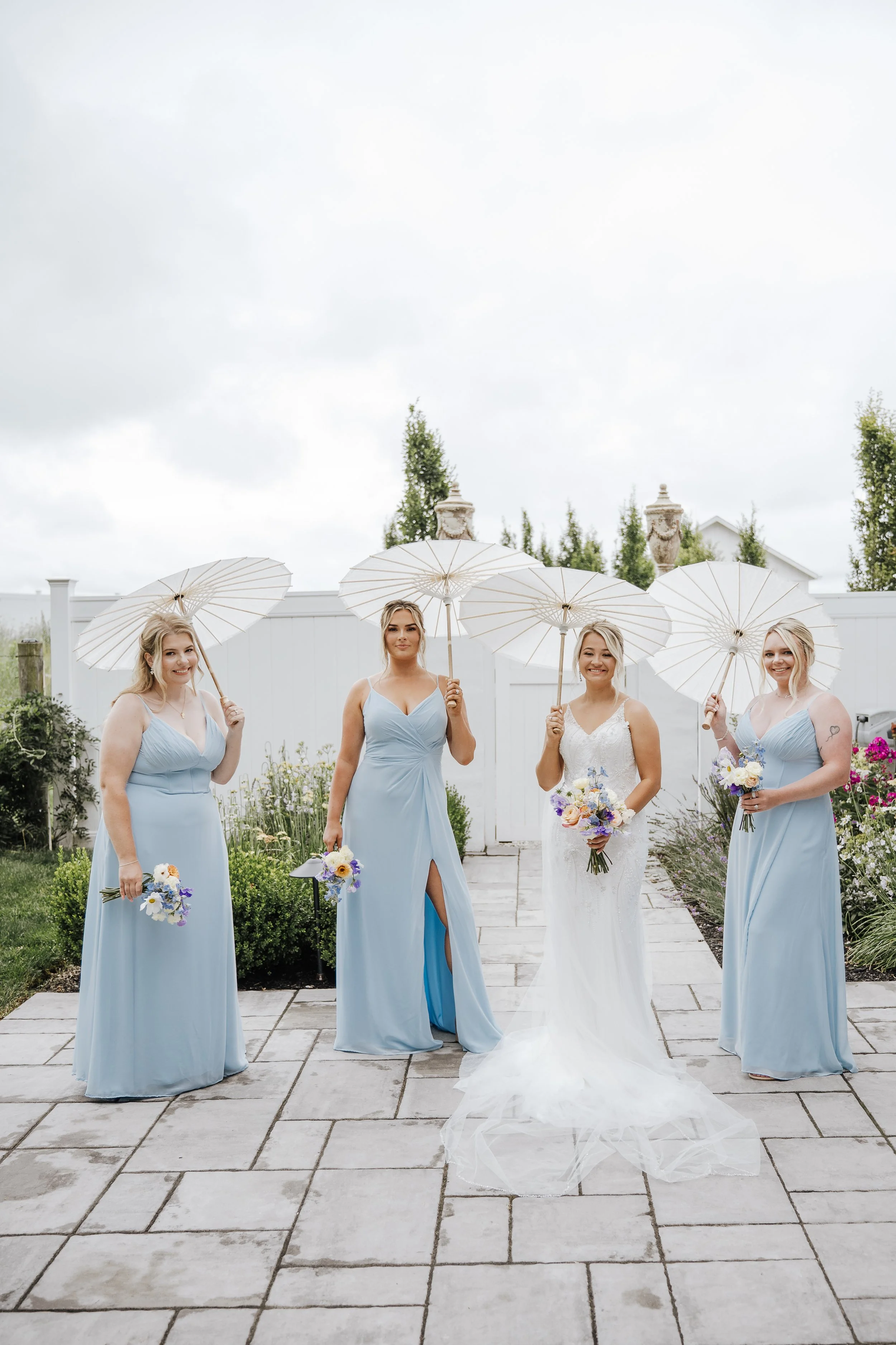 Bridesmaid portraits with parasols on the Aspen & Alston patio