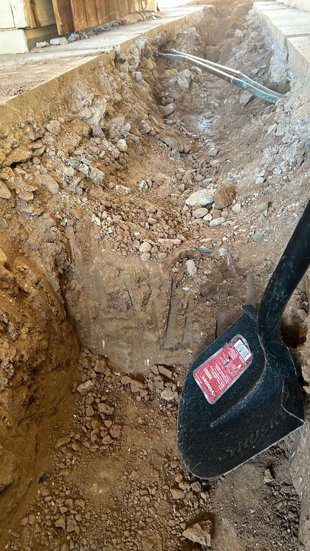 Hand digging the hard spots
