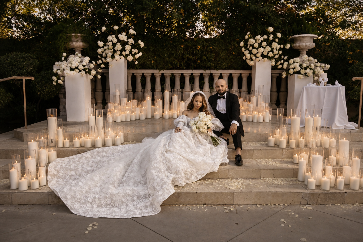 Elegant event space decorated with numerous white flowers, greenery, and candlelit pearl sand candles for a celebration or wedding reception in Arizona.