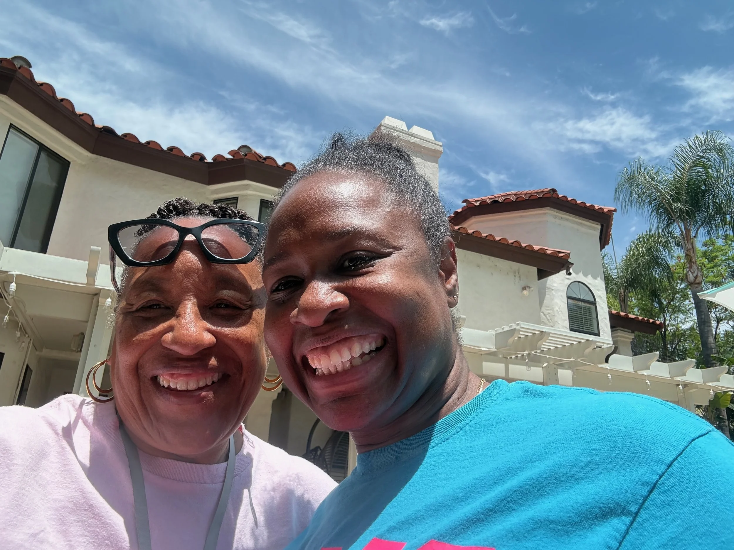 Two Sistering members laughing together at the retreat