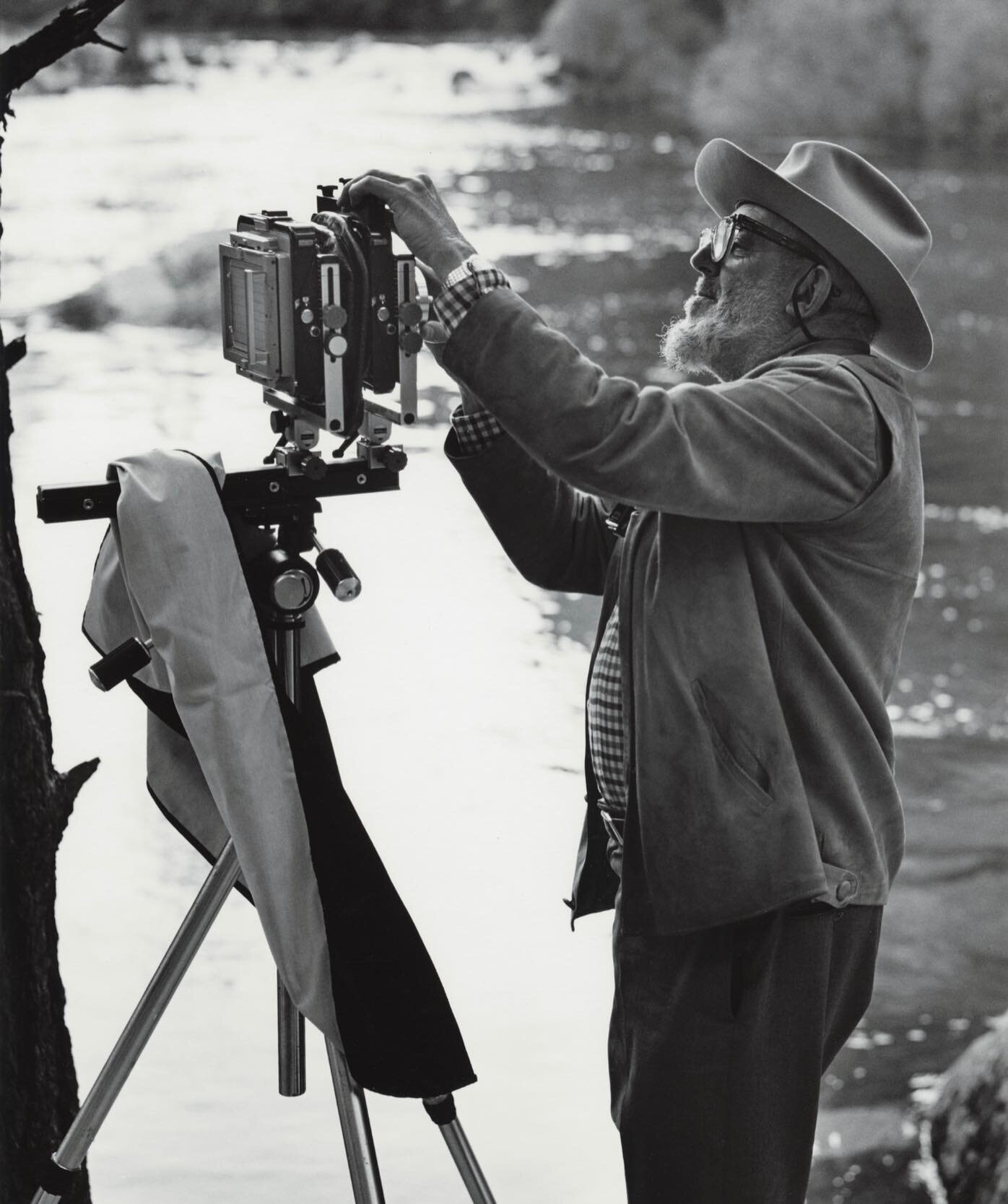 Ted Orland shows Adams as a working artist in the pursuit of a picture. Orland was an assistant and printer for Adams, and went on to have his own artistic career. The candid portrait showcases Adams in his creative element, surrounded by nature, his