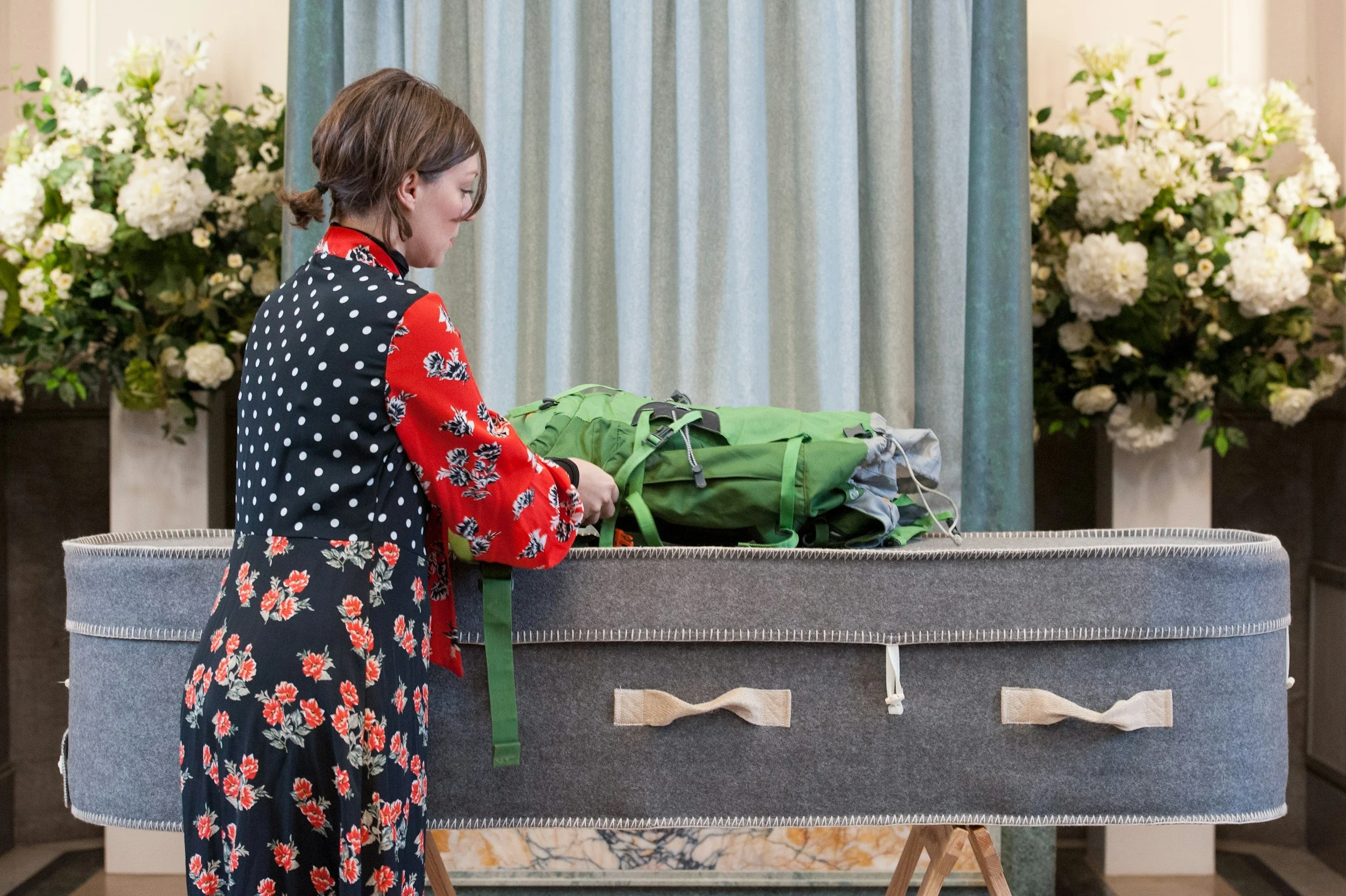 Celebrant laying bag over the coffin during a funeral ceremony