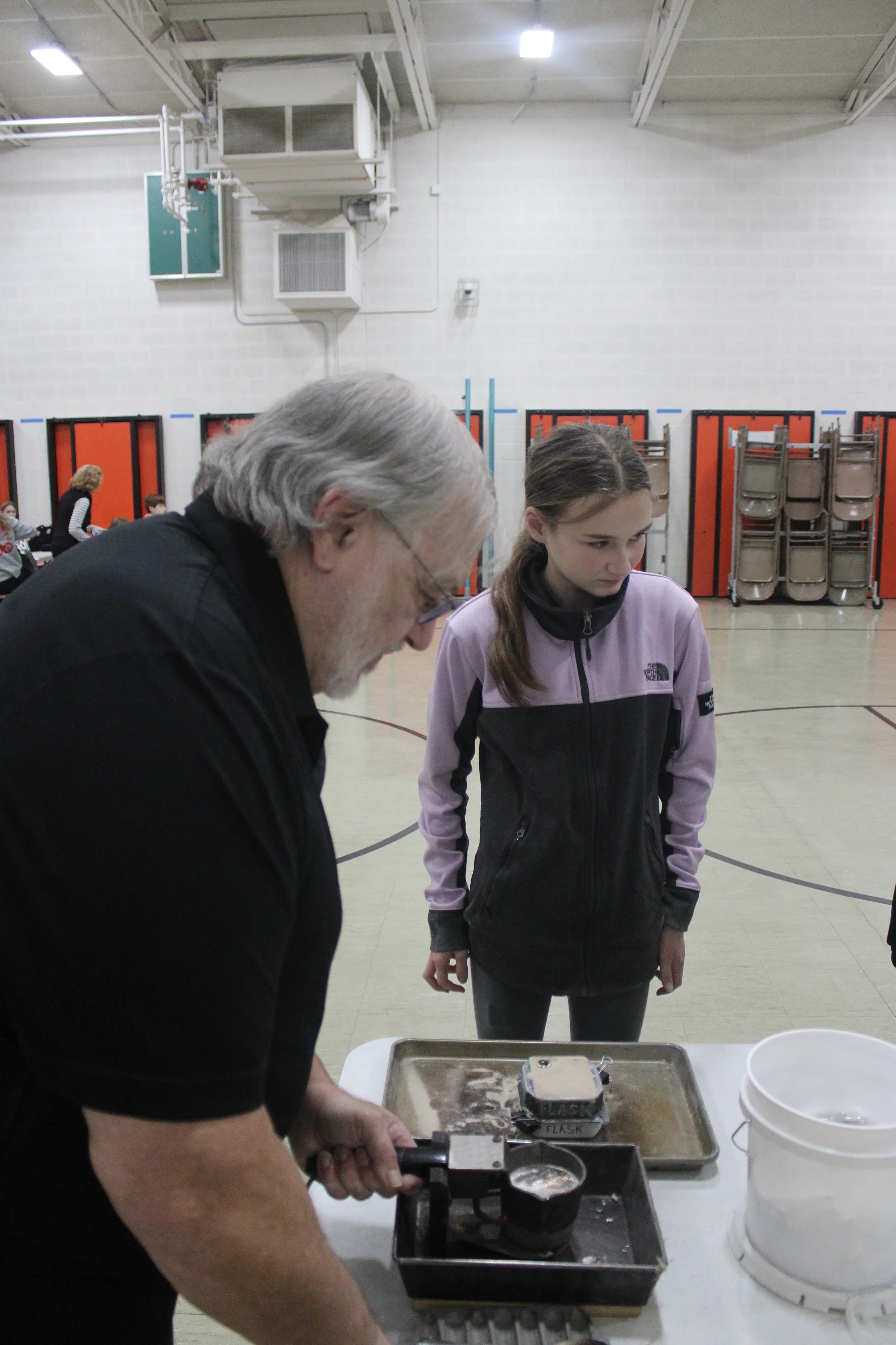 student pouring casting