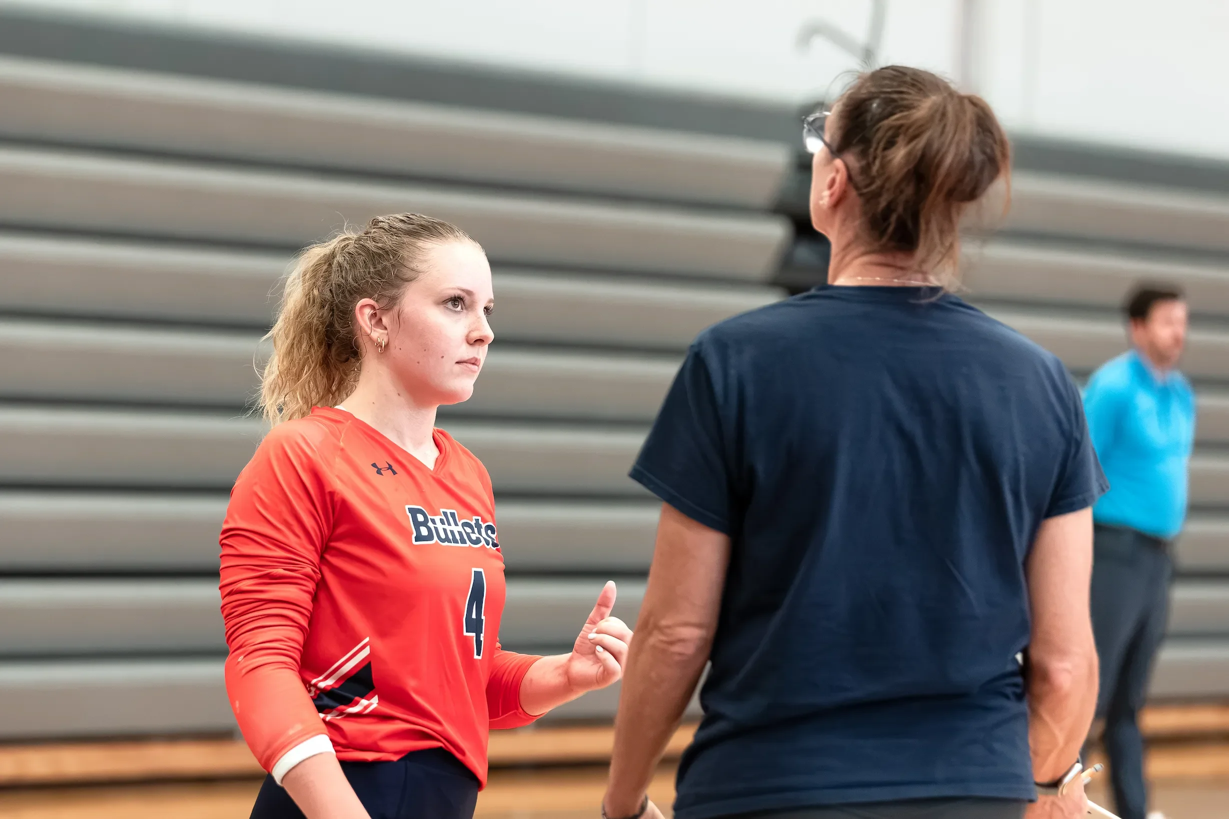 Volleyball player talking to coach