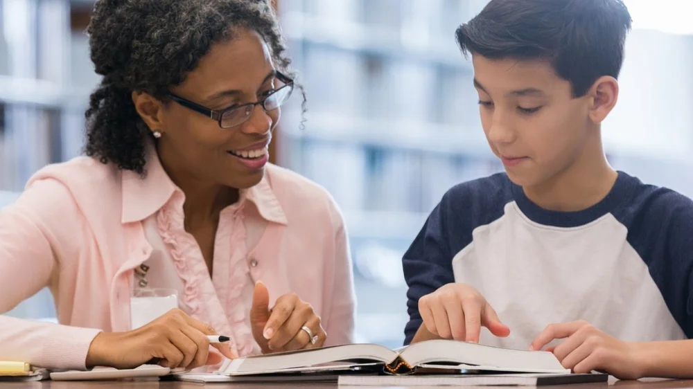Tutor reading one-on-one with a student
