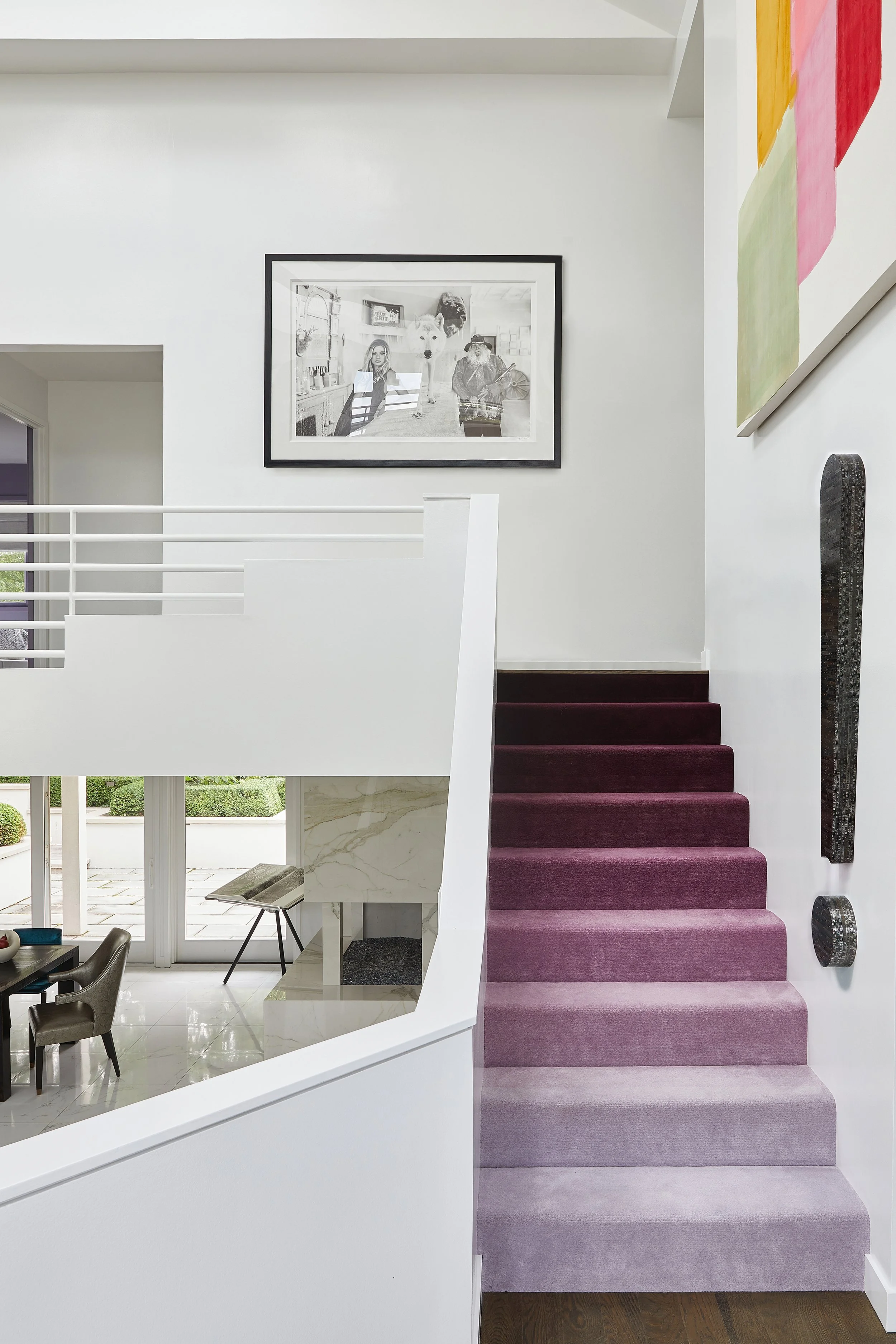 Interior redesign of a modern Chicago area home showing a staircase with purple carpet and white walls.