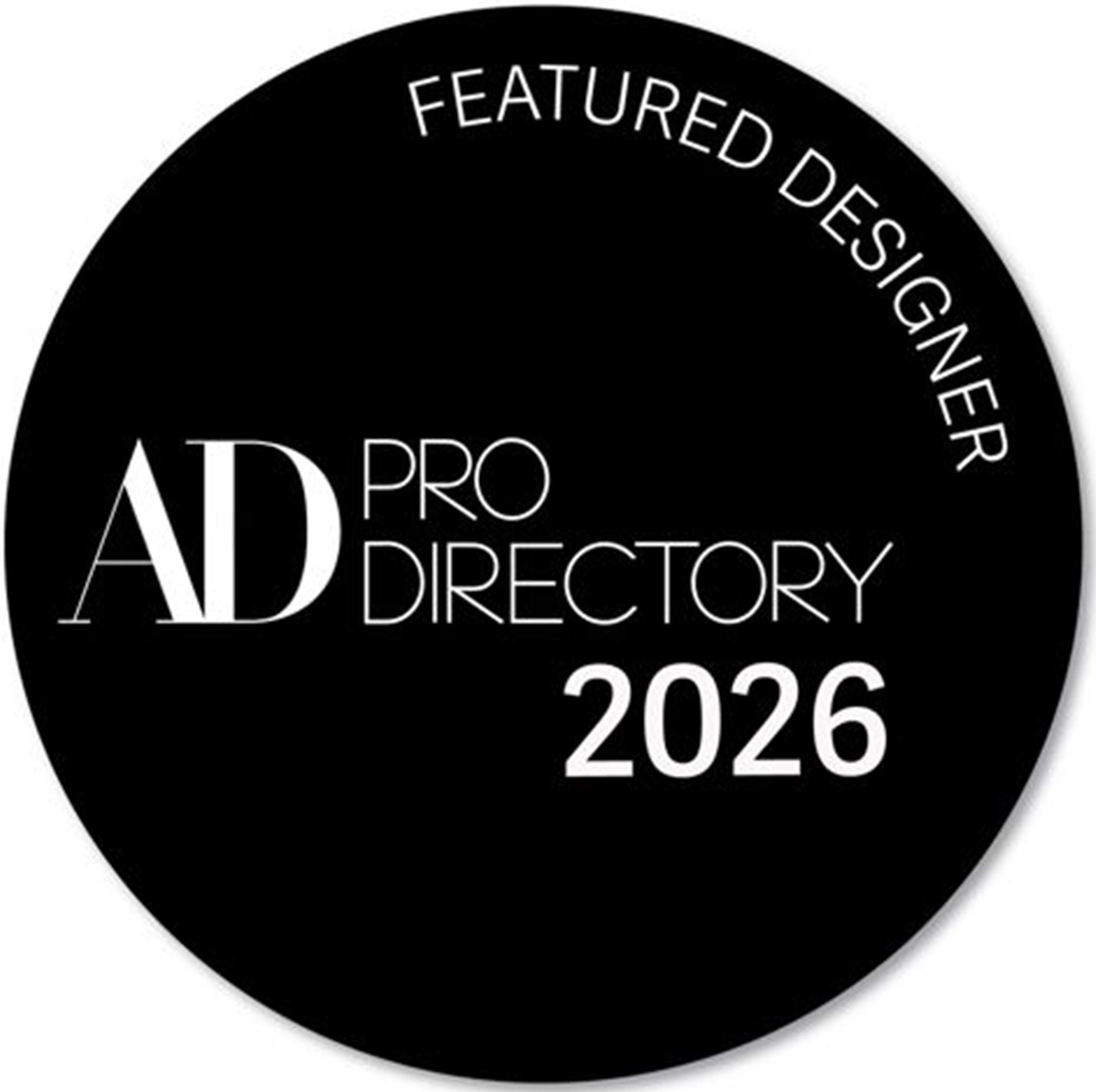 Black circular badge with white text that reads 'Featured Designer AD Pro Directory 2026' and 'AD PRO' prominently displayed in the center.