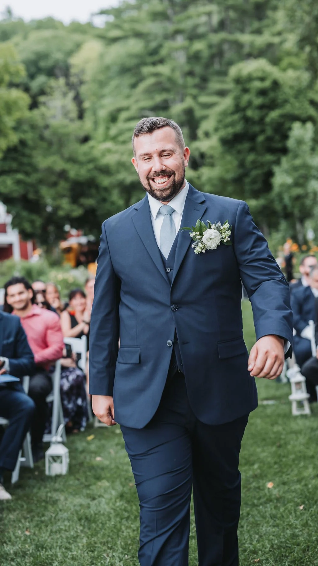 Groom walking down isle at Newfound lake Inn New Hampshire Wedding