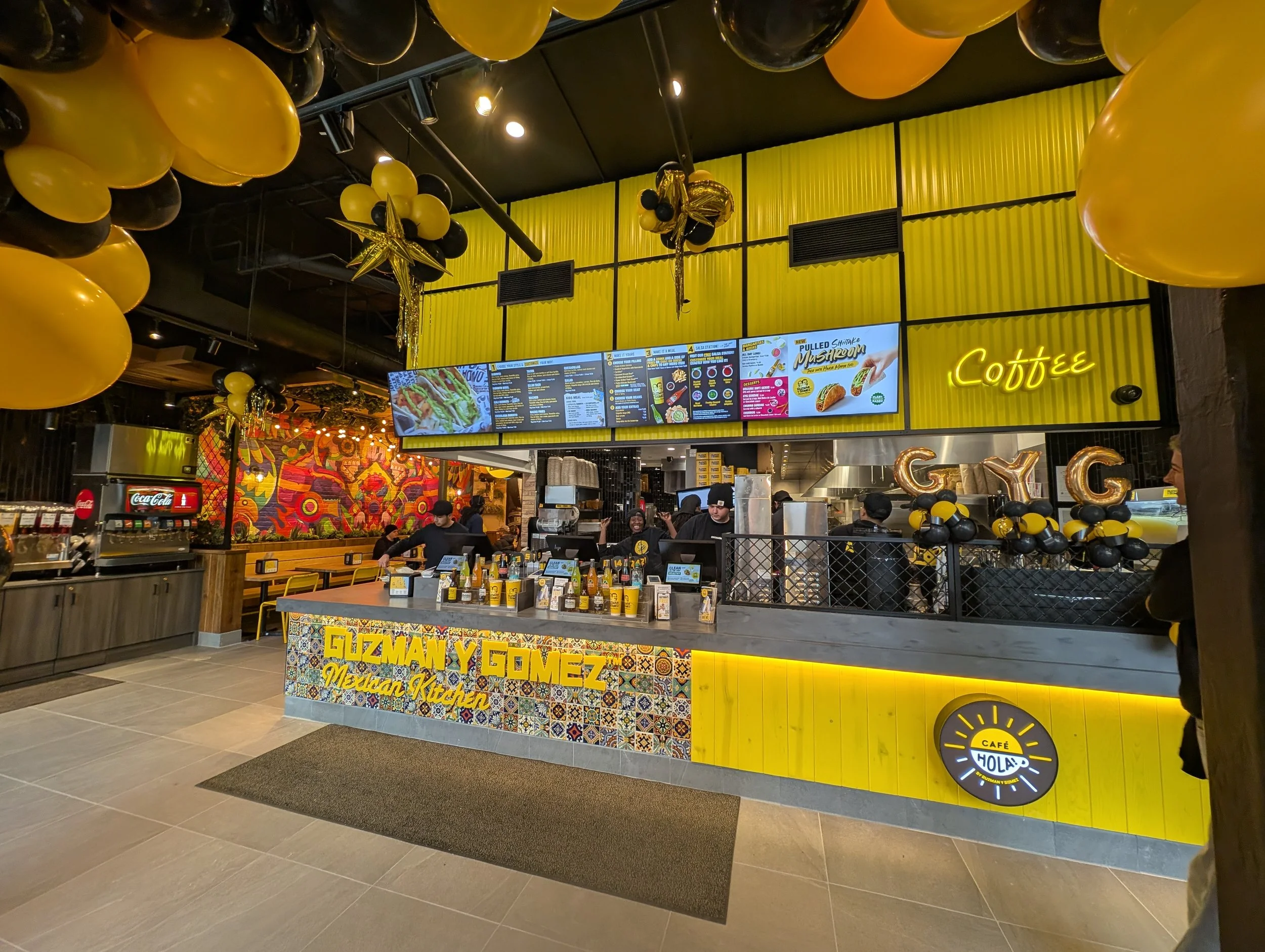 Distinctive powder-coated yellow metal wall panels at GYG Bucktown, fabricated by Vero