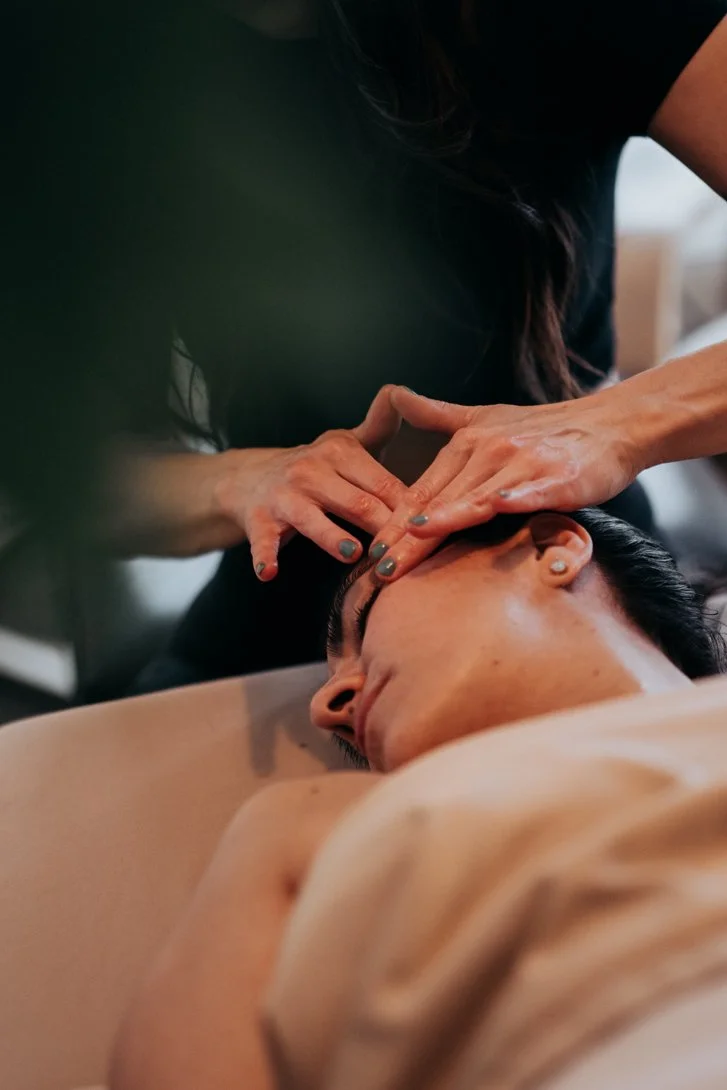 A person receiving a facial massage that includes massage, Gua Sha, therapeutic facial cupping, lymphatic drainage and nervous system care in Edmonton.