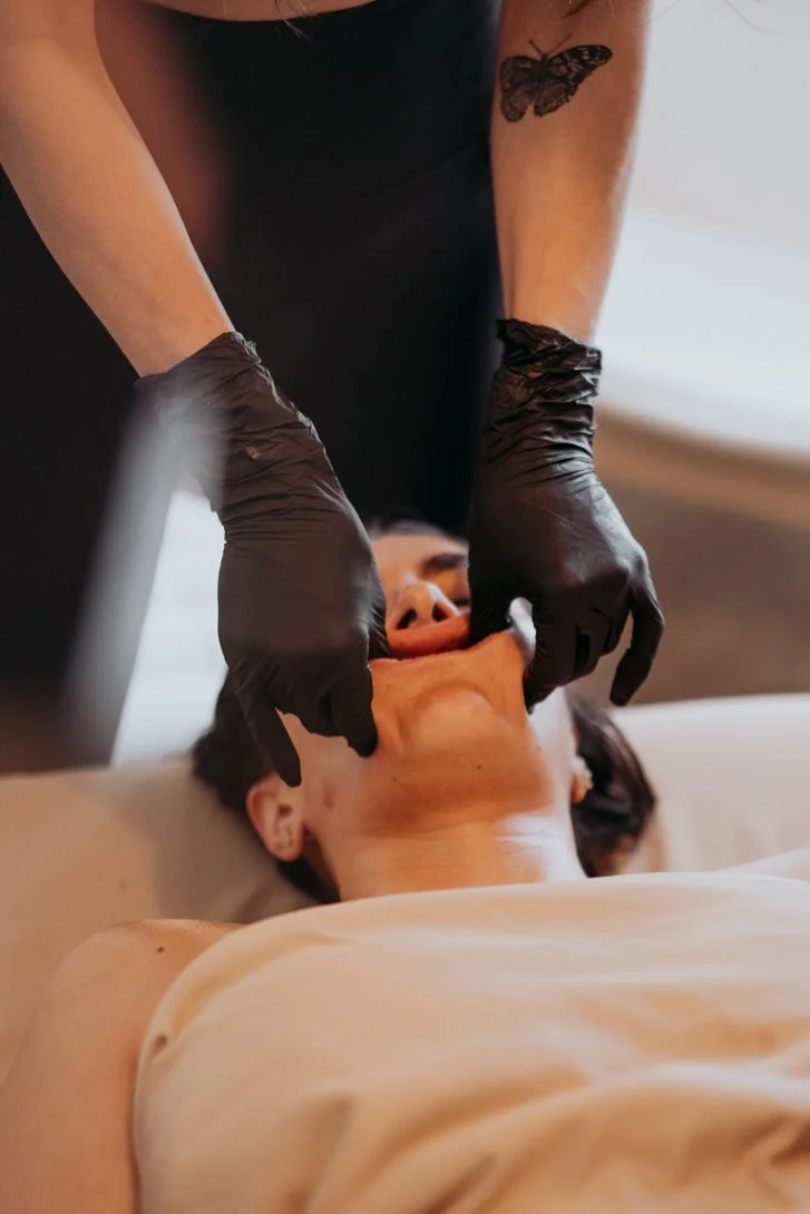 Intra-oral buccal massage treatment for jaw tension, TMJ discomfort and facial release at Koselig Wellness in Edmonton, Alberta.
