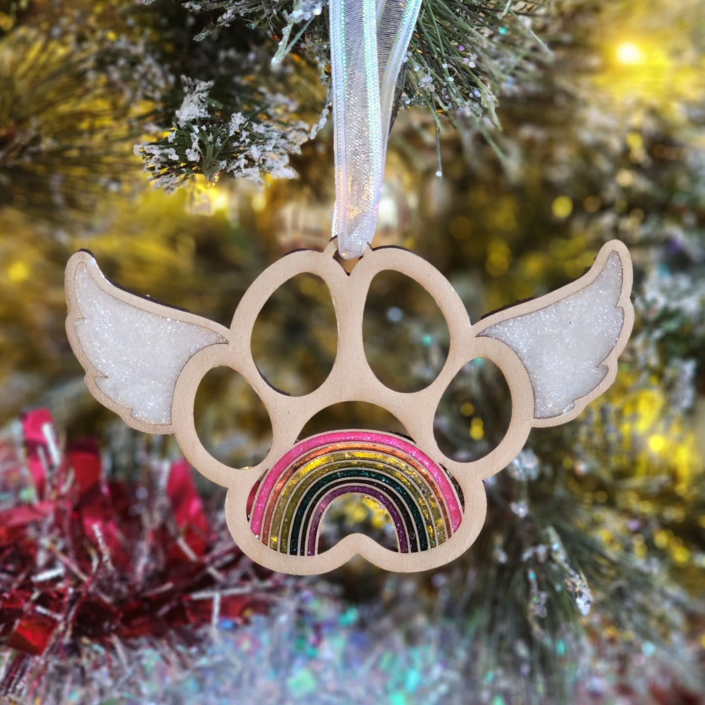 I created this Rainbow Bridge memorial ornament to honor the furry friends who&rsquo;ve left pawprints on our hearts. Each one features a raised paw with delicate wings and a hand-poured resin rainbow &mdash; a small, shining reminder that love never
