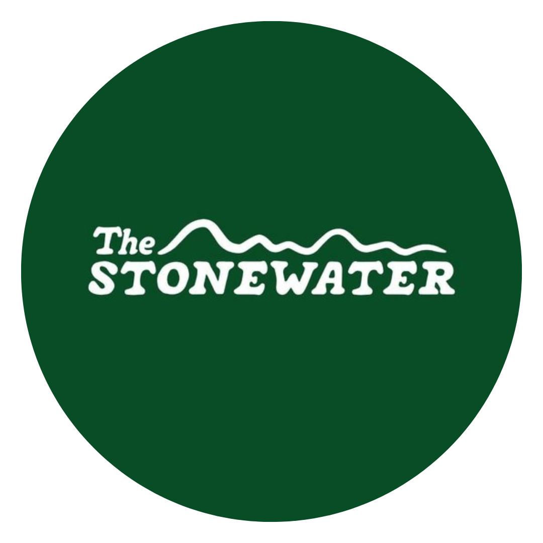 Logo for The Stonewater with white text and a mountain line on a dark green background.