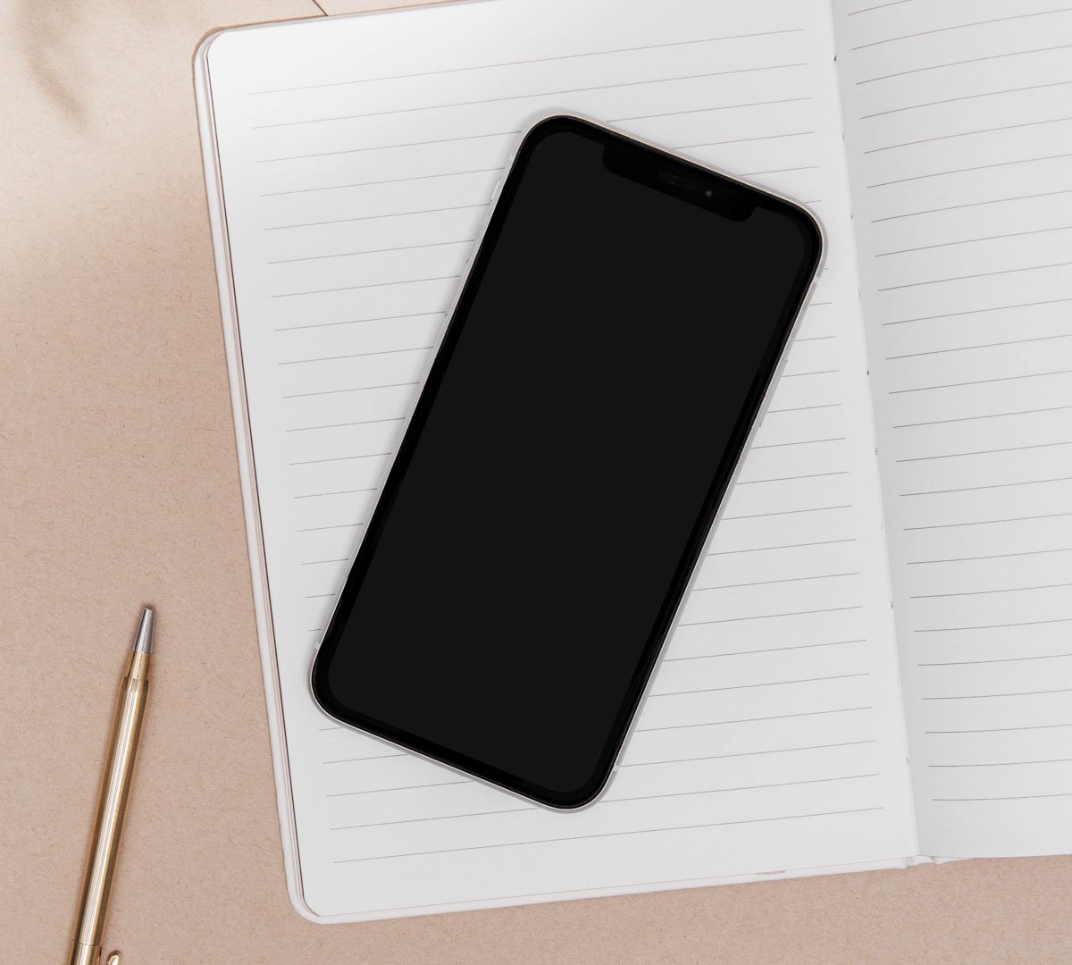 phone on notepad with pen