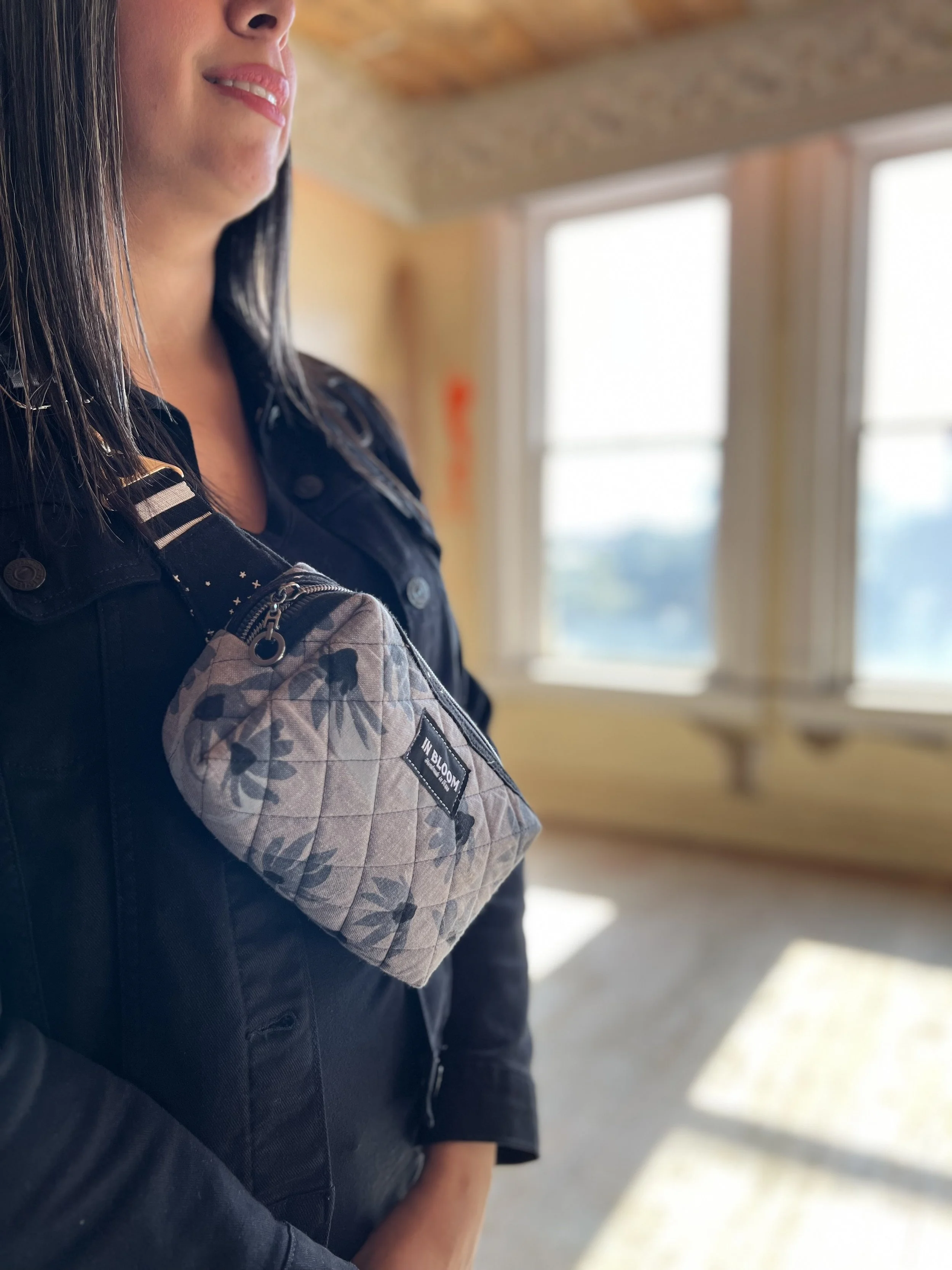 A crossbody bag made by Bri, featuring her personalized woven label.