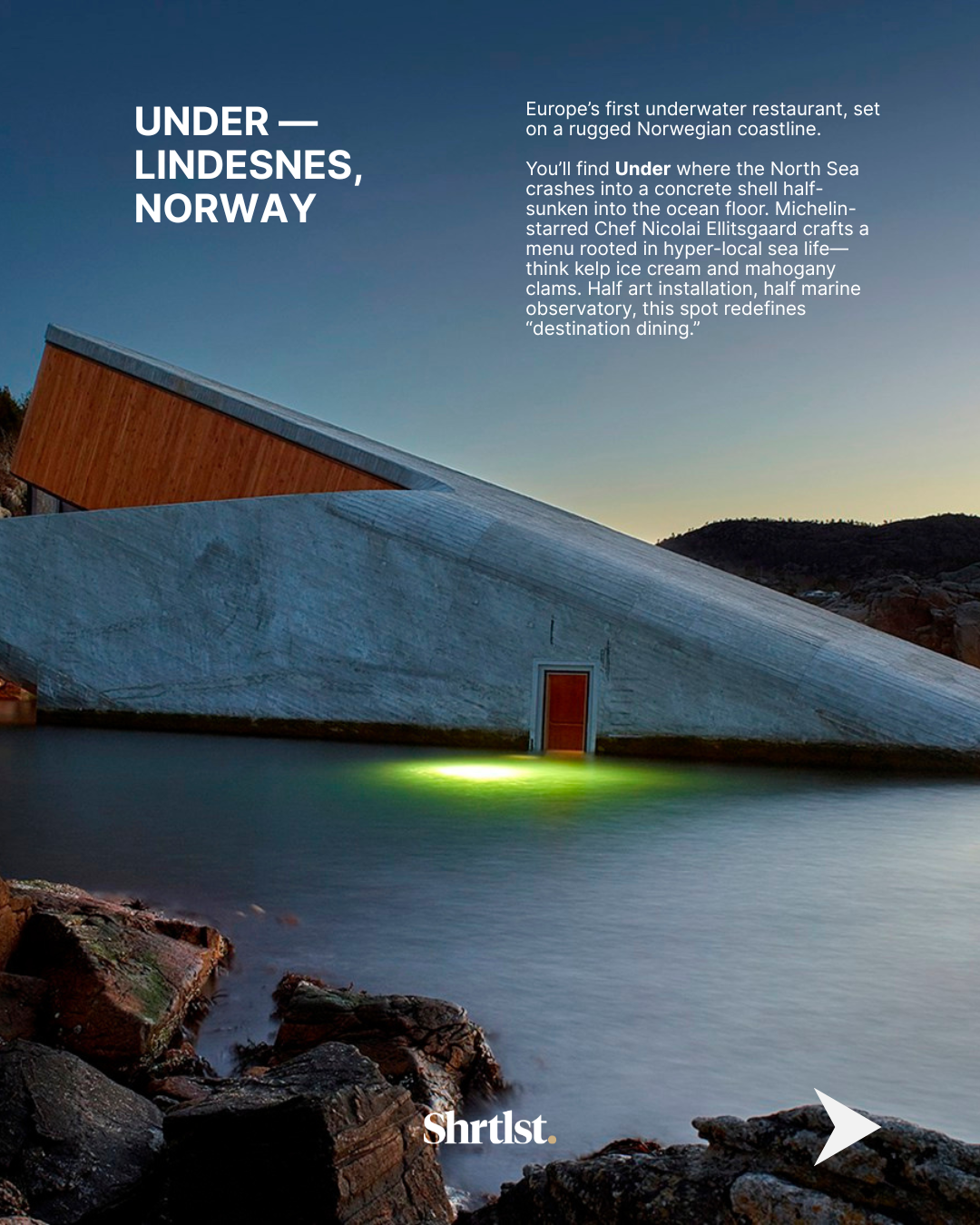 A modern, angular building with concrete and wood exterior partially submerged in water, set against a rugged coastline at dusk. The building is Norway's first underwater restaurant, Under, located on a Norwegian coastline.