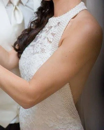 Handworked Swarovski pearls and crystal seed beads embellish the neckline.