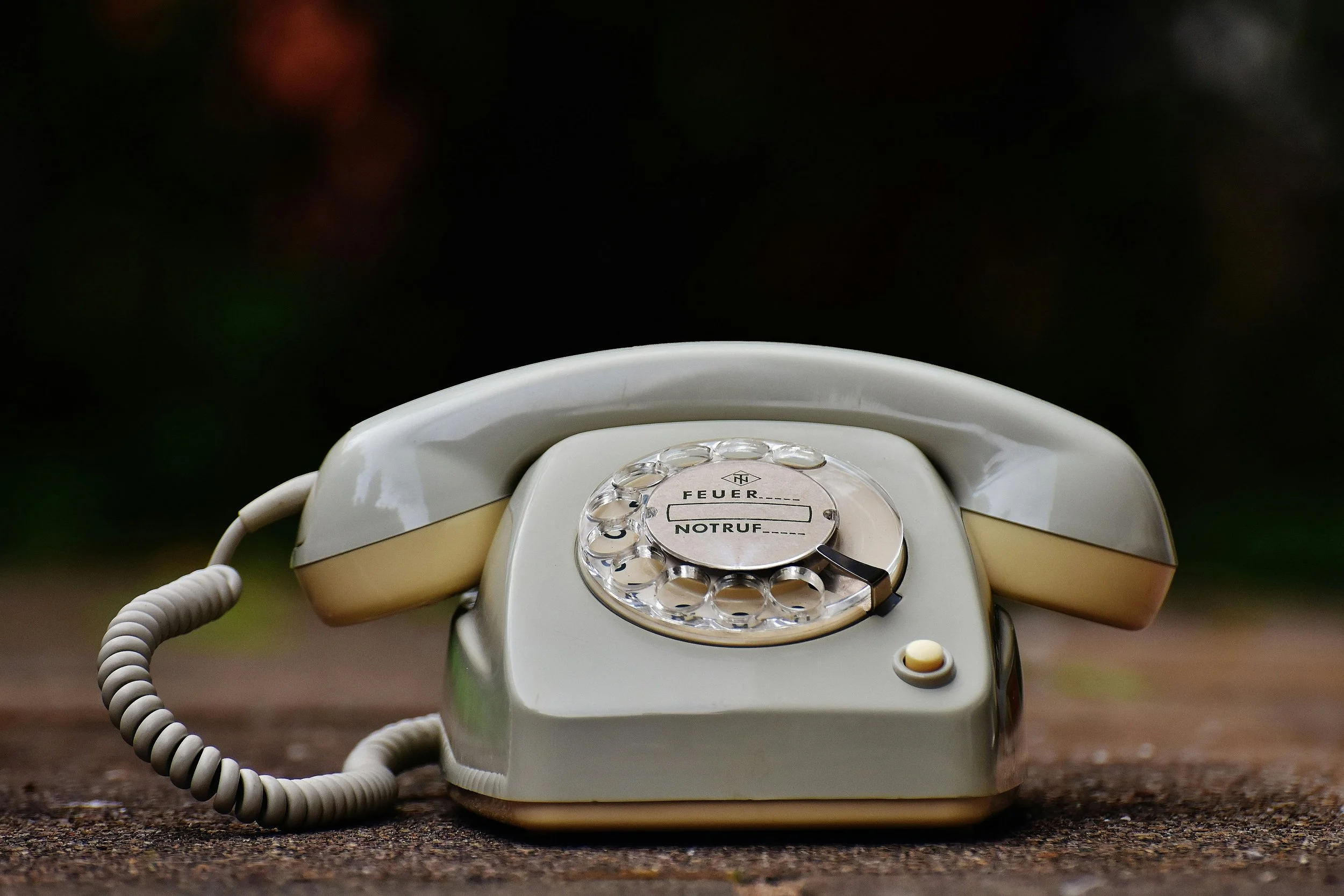 Vintage telephone - Photo by Pixabay gray rotary telephone on brown surface