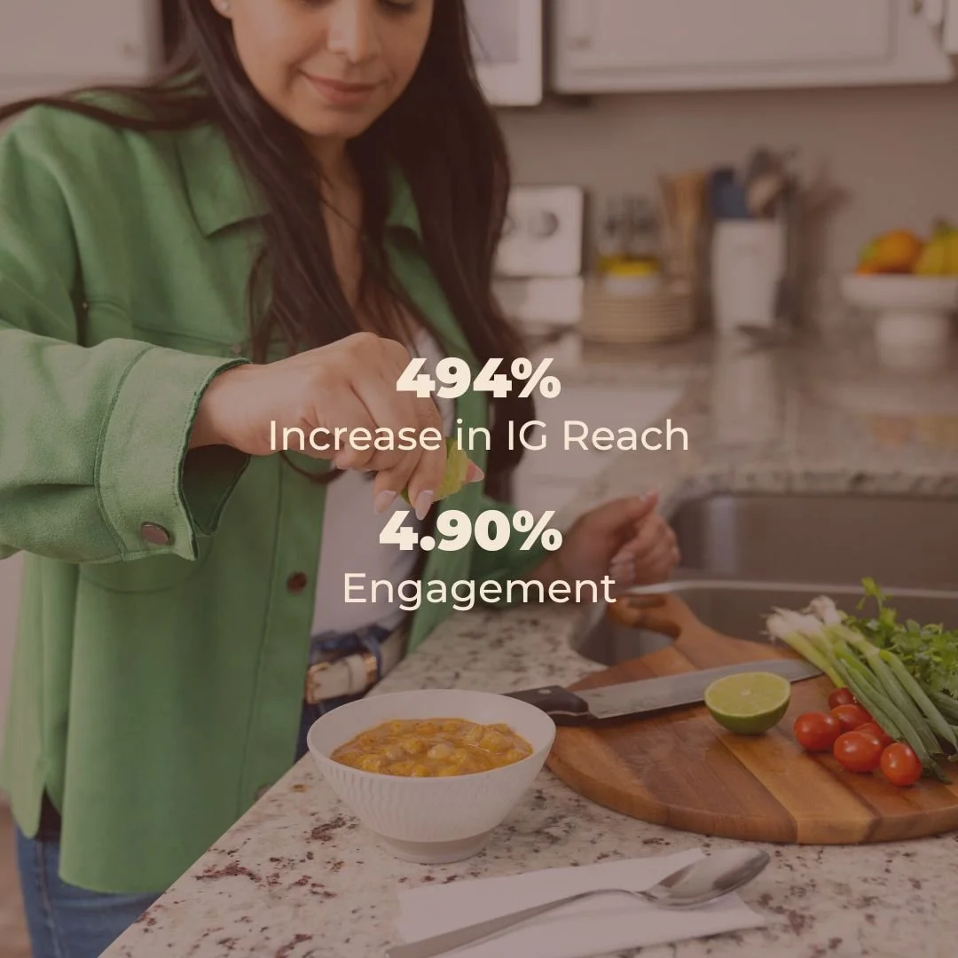 Woman in green jacket squeezing lime over bowl of salsa on kitchen counter with vegetables and lime nearby. The Apricots Media. Social Media Agency for CPG, DTC and Hospitality brands.