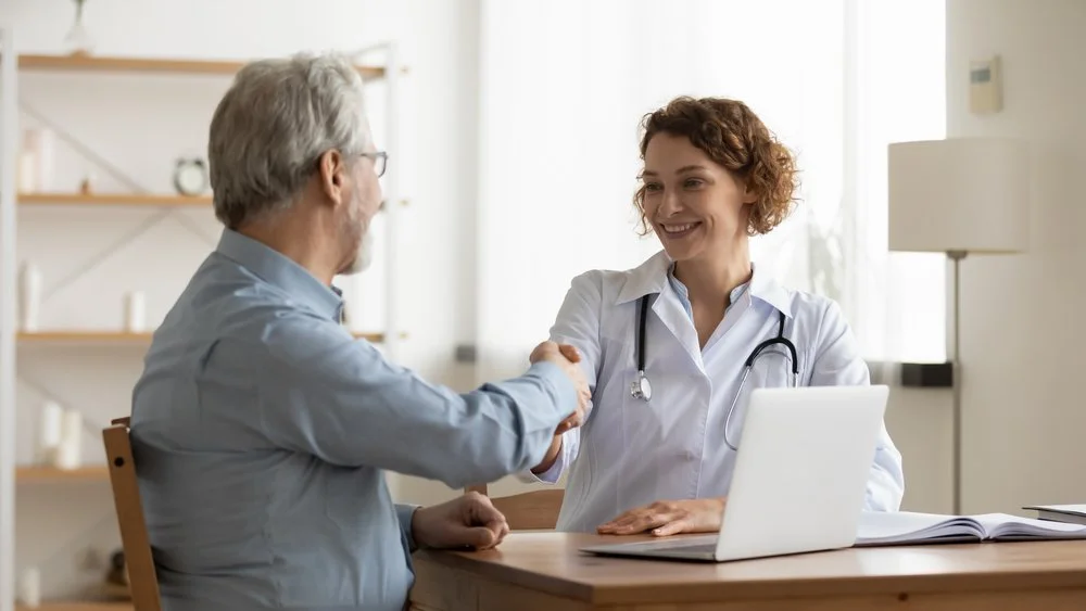 Physician reviewing patient billing at a desk