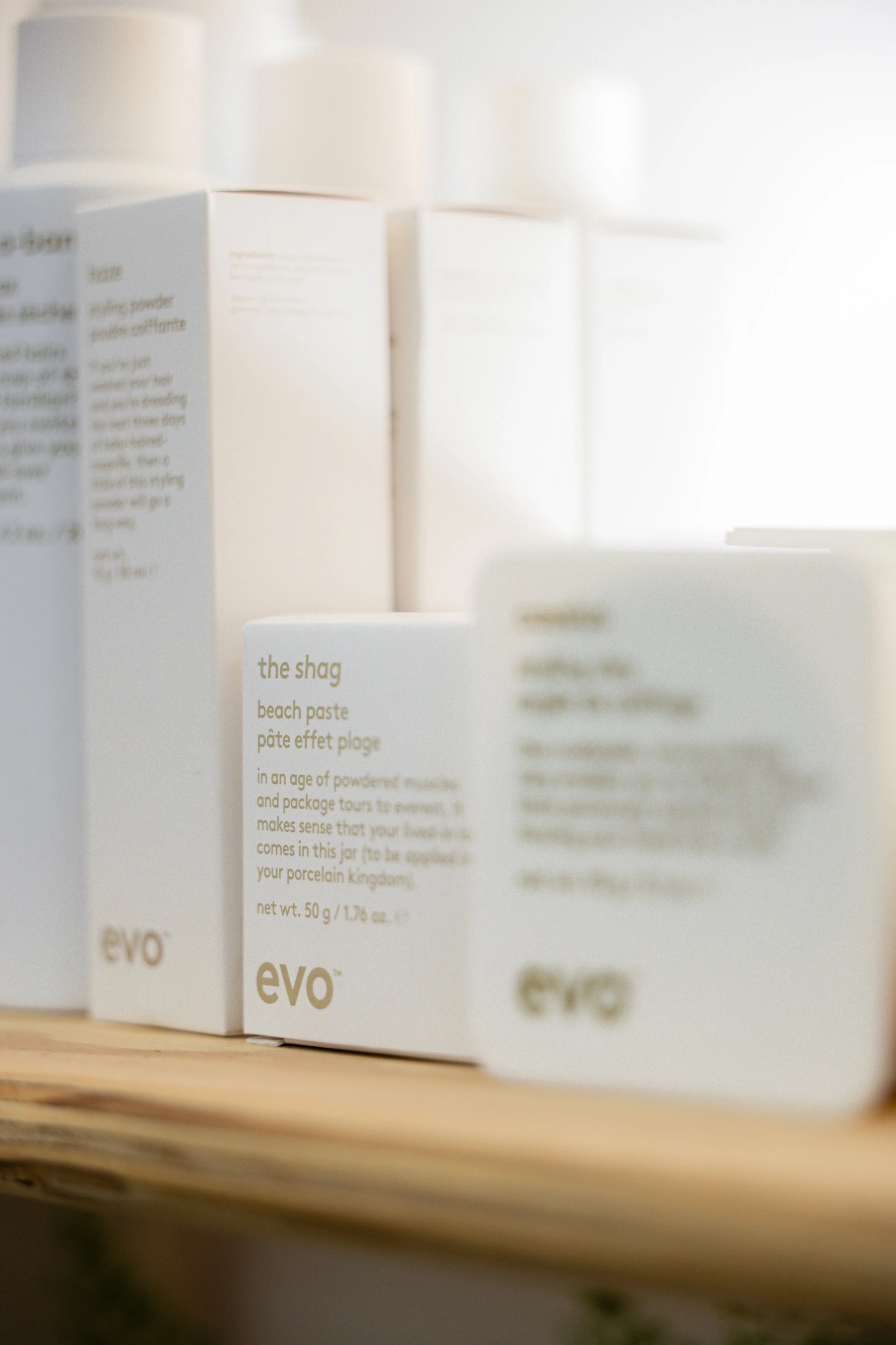 Evo styling products displayed at Travis Hairdressing, used for texture, hold, and salon hair styling.