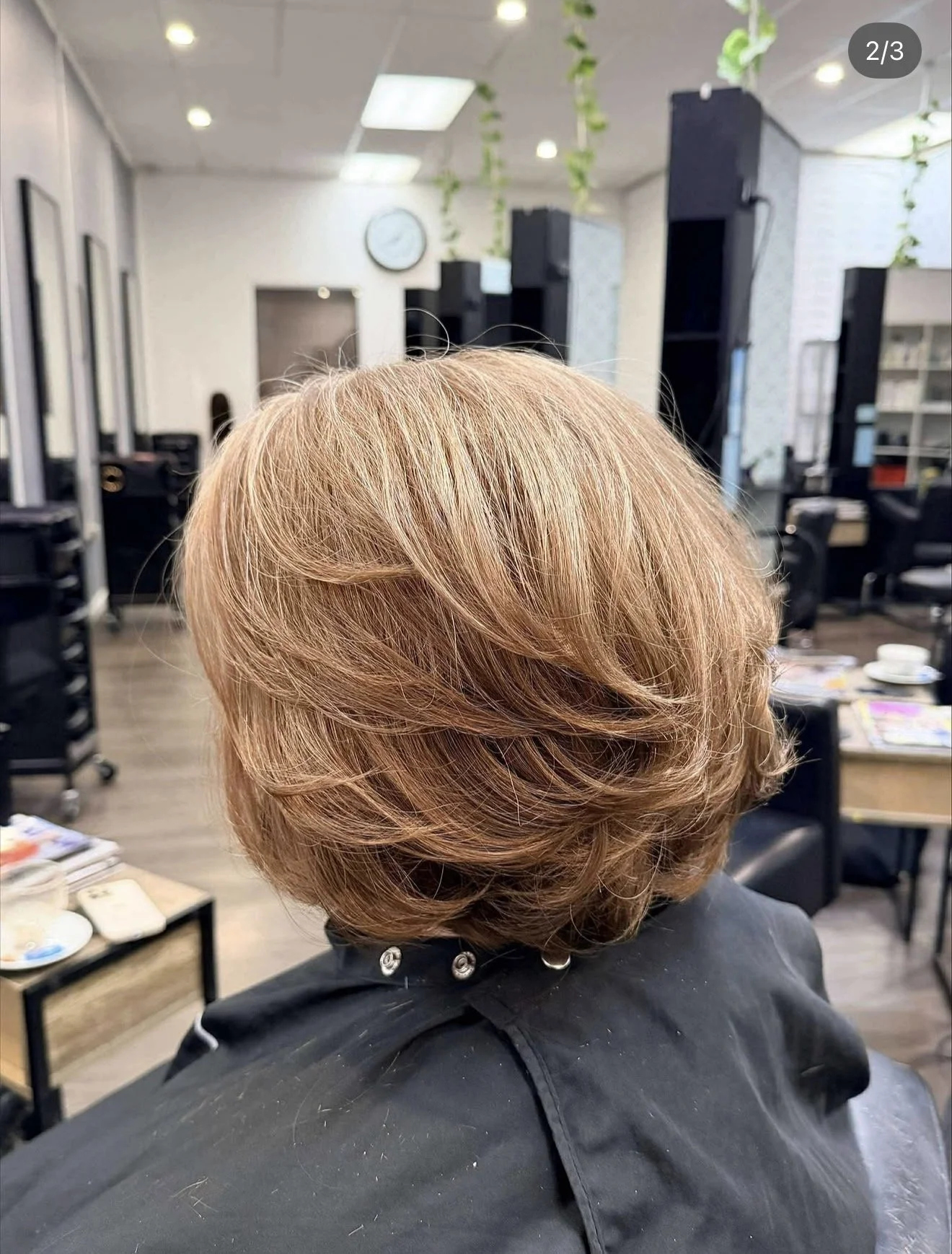 Short layered haircut with warm colour and volume created at Travis Hairdressing.