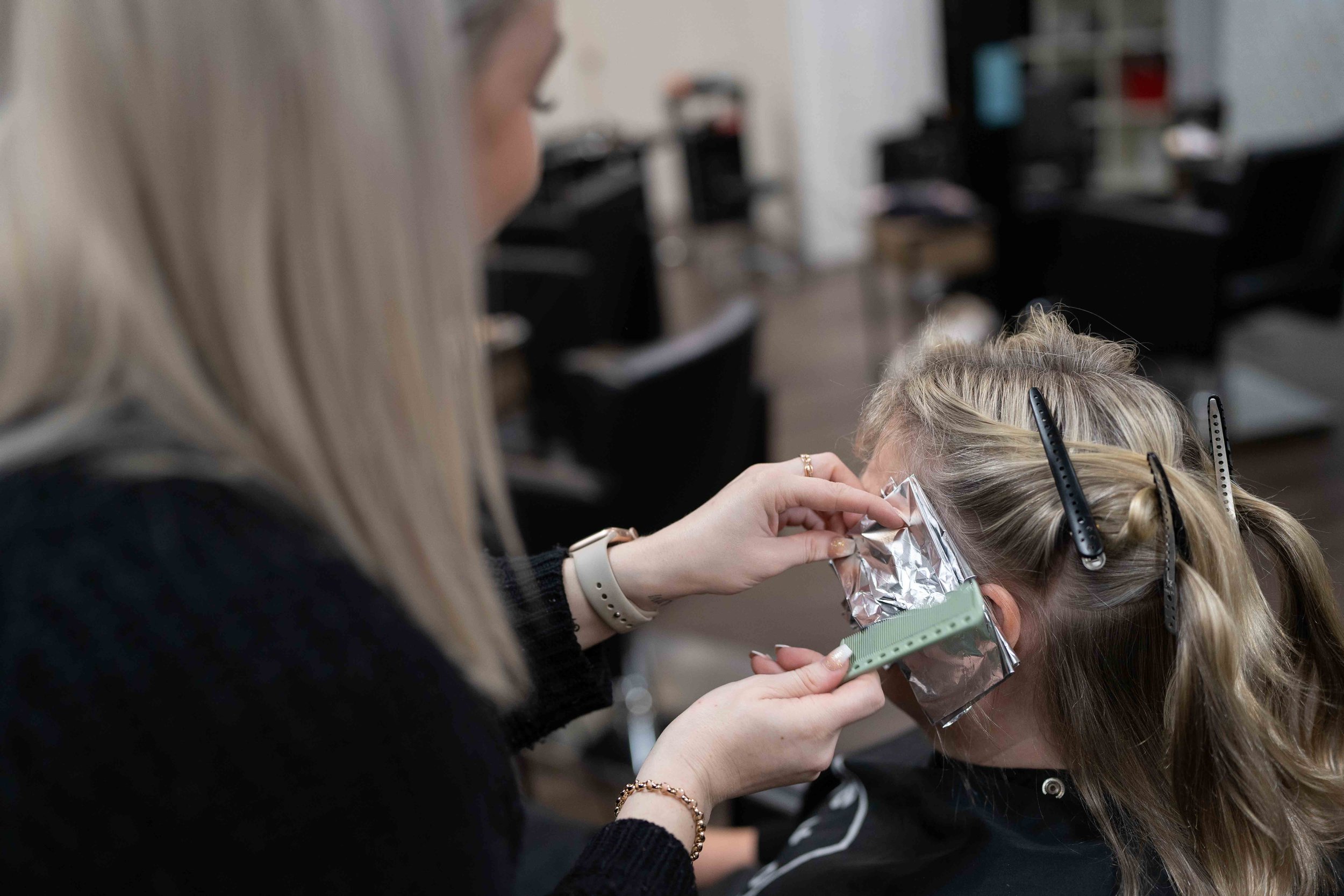 Hair colour being applied with foils at Travis Hairdressing, a Blackwood hair salon offering colour and foiling services.