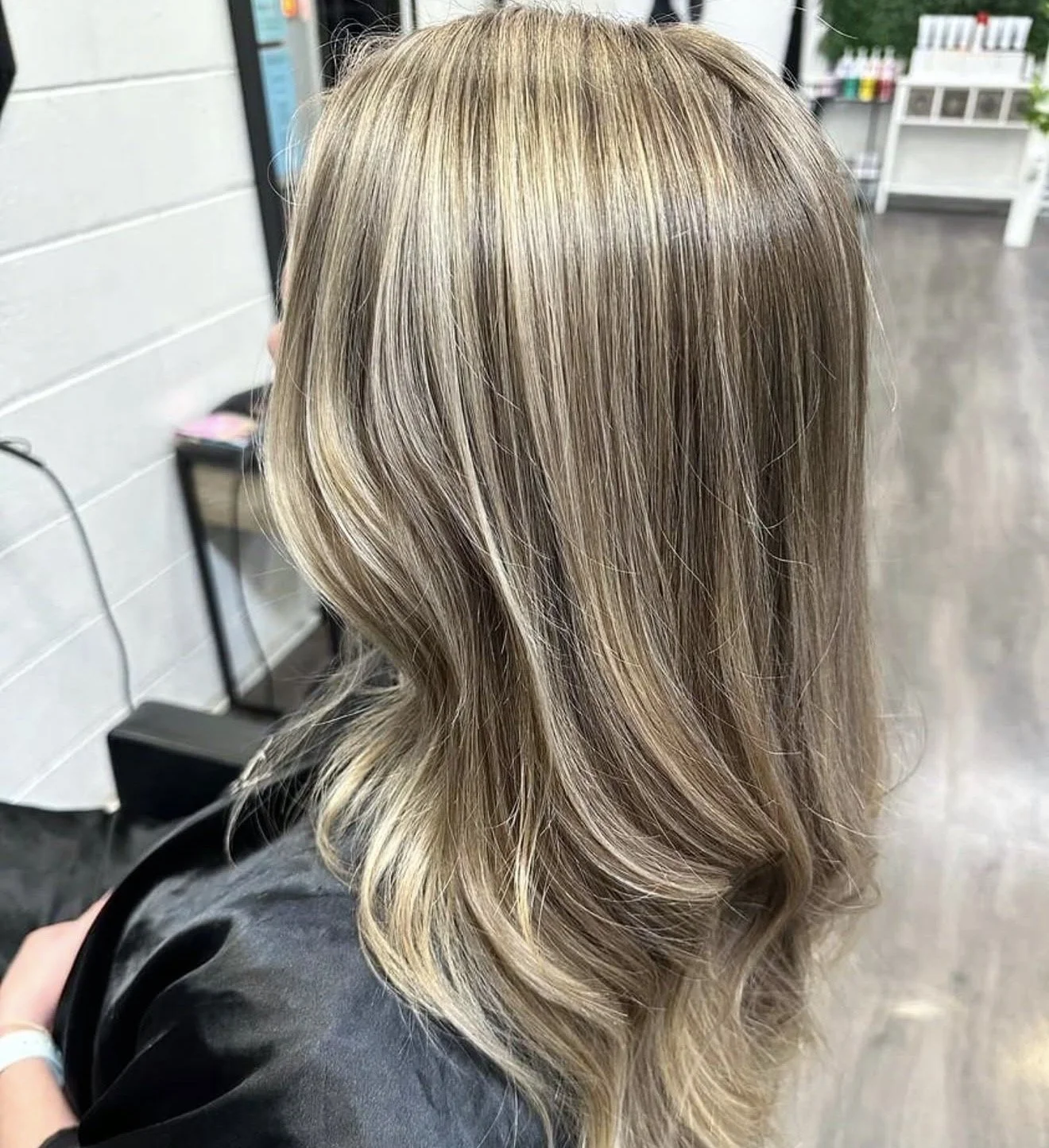 Soft blonde balayage with smooth waves created at Travis Hairdressing in Blackwood.