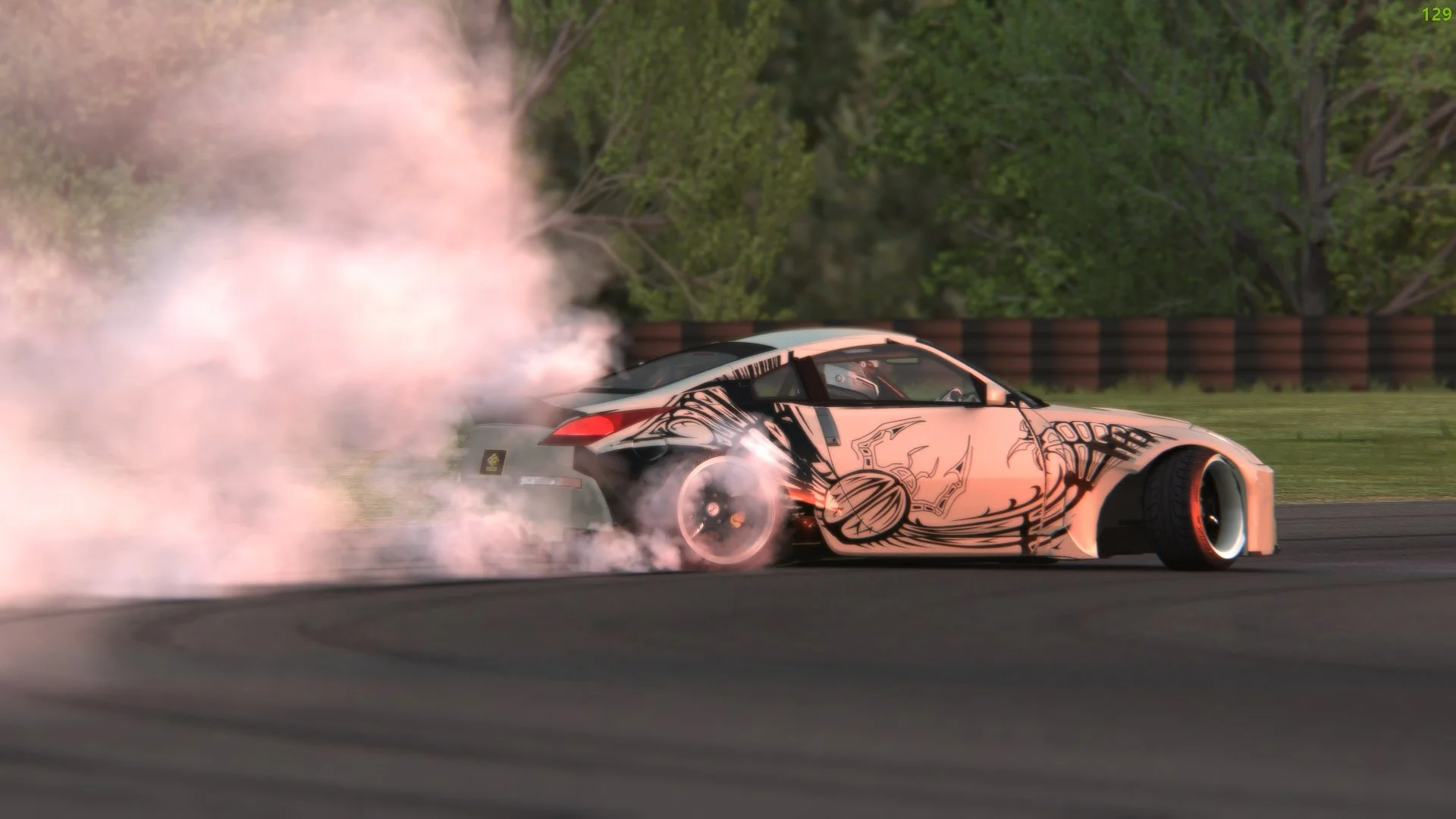 A race car drifting on a track, emitting smoke from its rear tires, with trees and a safety barrier in the background.