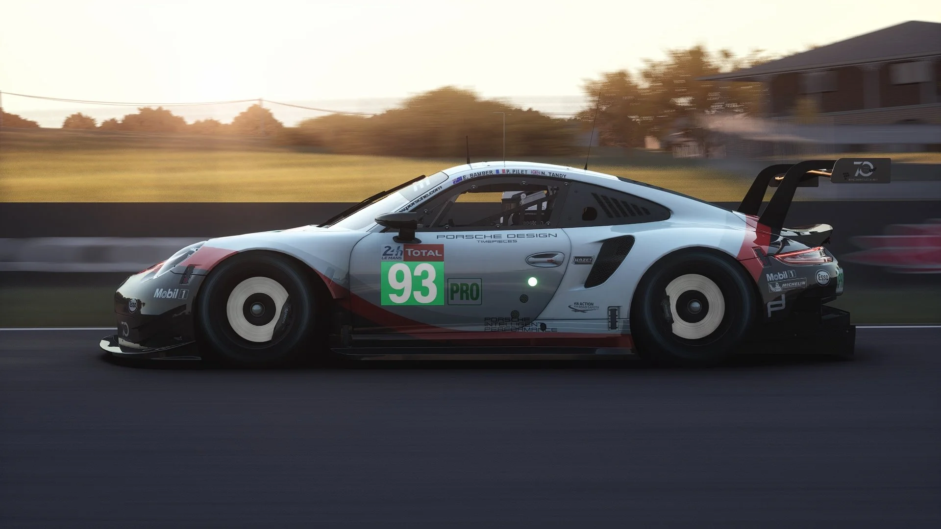 A Porsche racing car on the track during a race, with the number 93 displayed on its side.