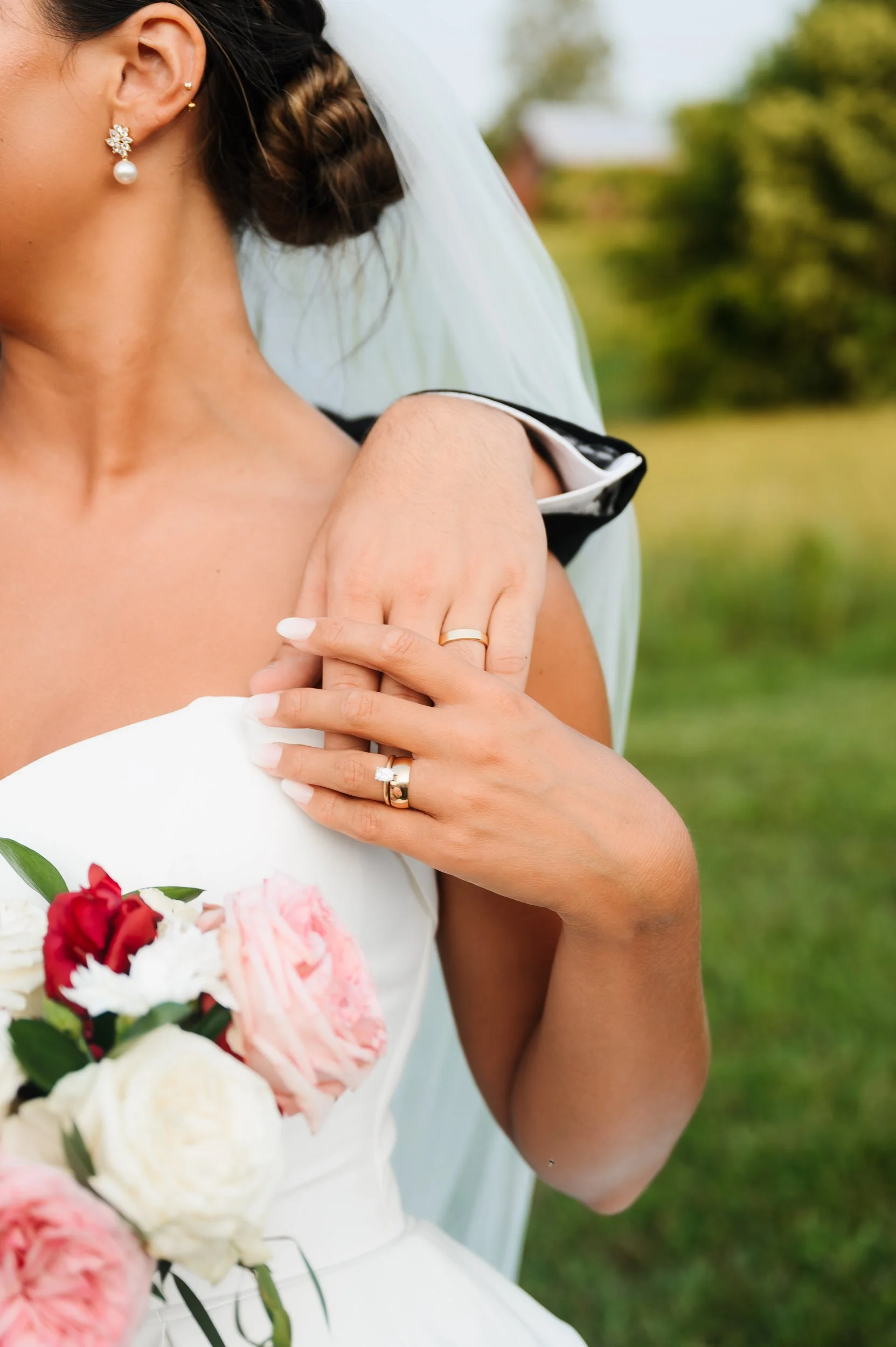 Close-up bridal portrait wedding ring detail photographed outdoors during wedding day