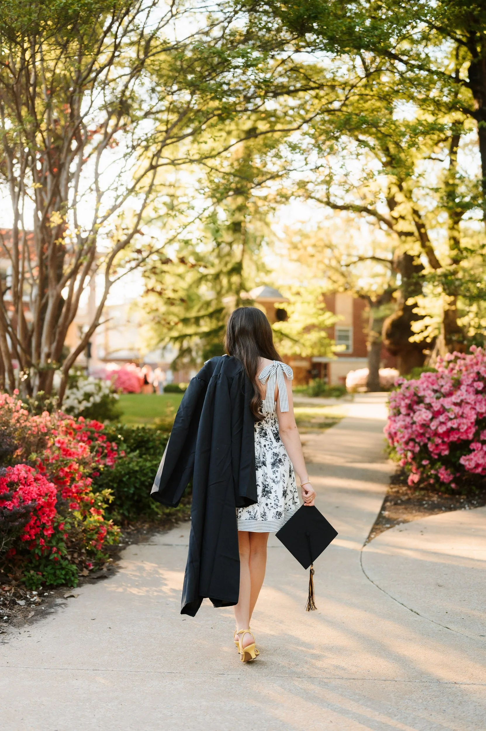 Graduate wearing cap and gown during outdoor graduation session