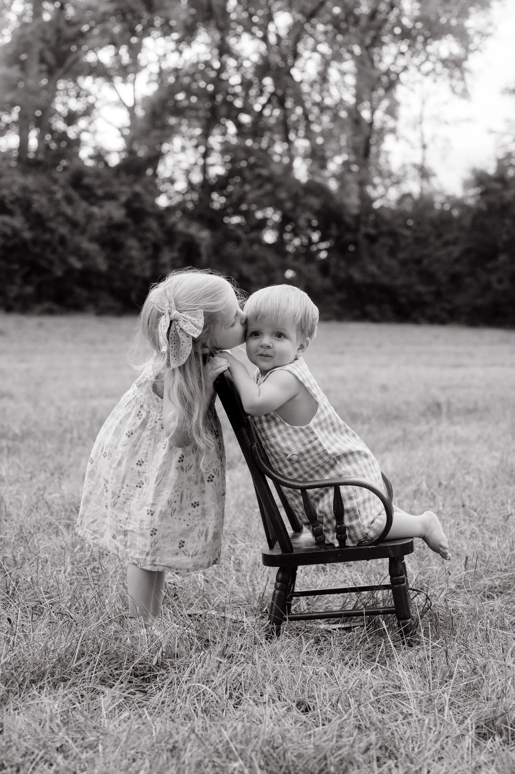Children embracing during black and white outdoor portrait family session