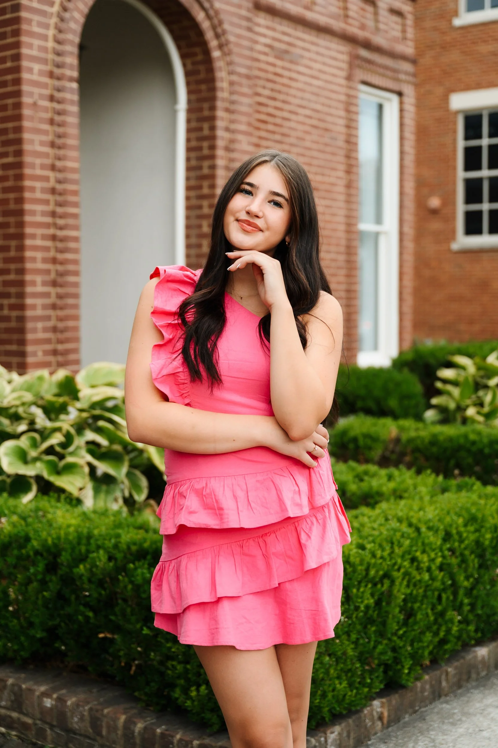 High school senior girl in pink dress posing outdoors in Brentwood Tennessee