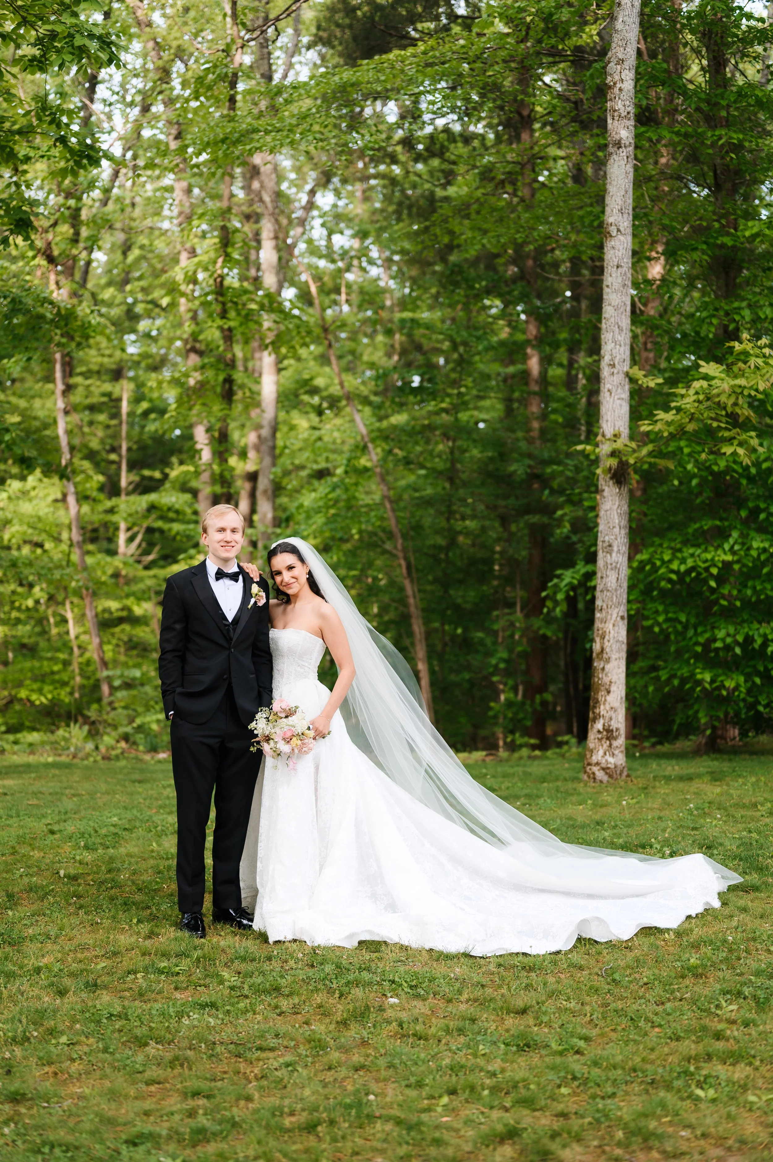 Bride and groom standing together outdoors during forest wedding portraits at Firefly Lane in Dickson TN