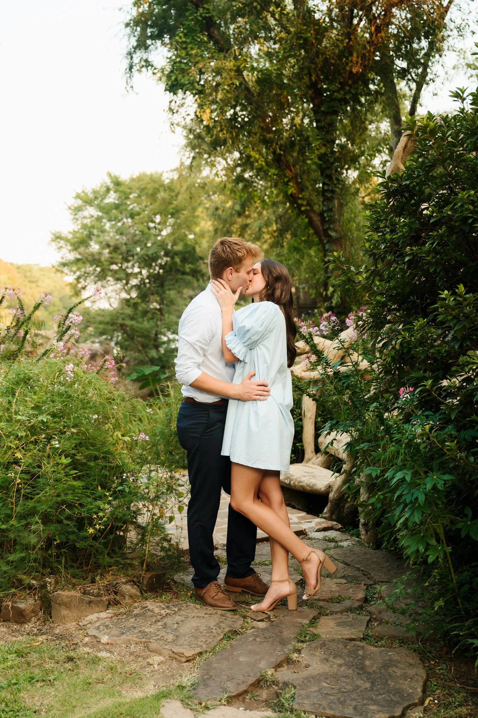 Couple kissing outdoors in a garden during Tennessee proposal session