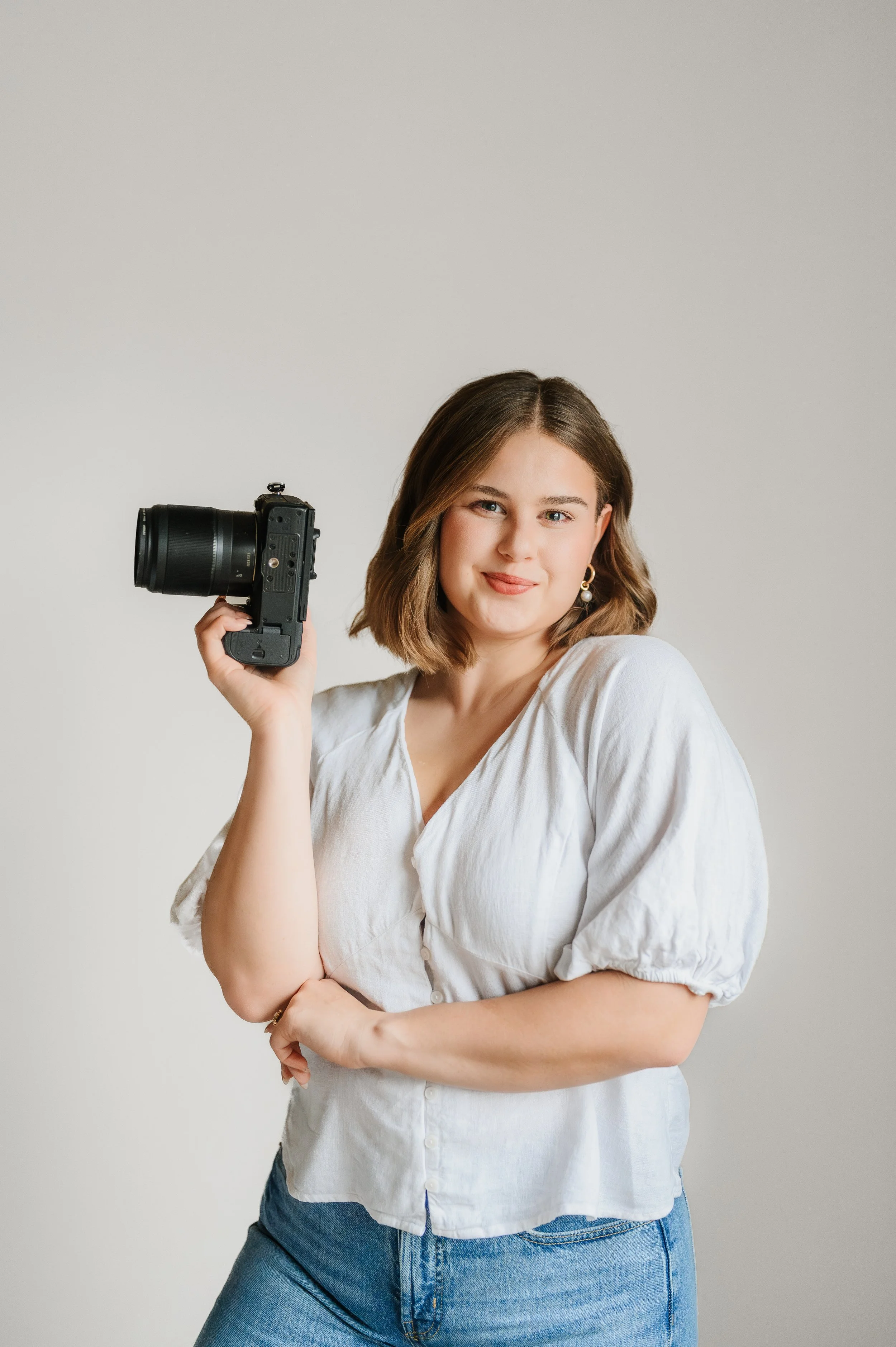 Nashville wedding photographer Abigail Garrison holding camera during branding session