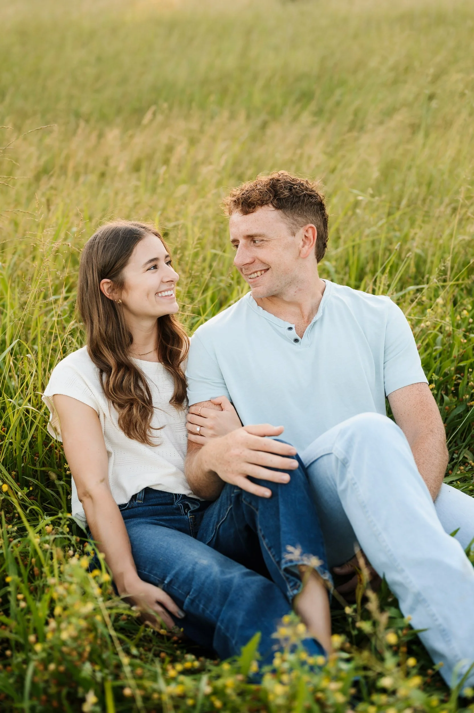 Couple posing together in grassy field during Tennessee portrait engagement session