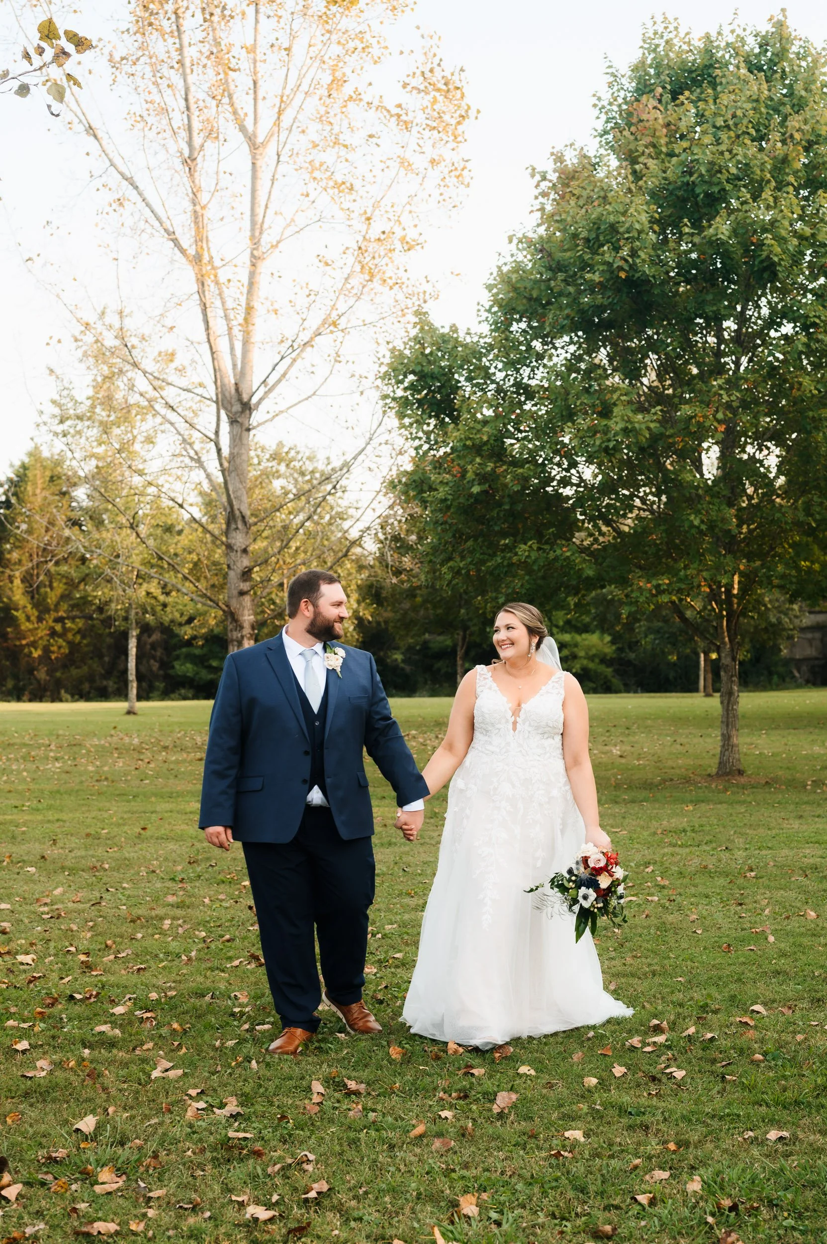 Bride and groom walking outdoors during fall wedding portraits