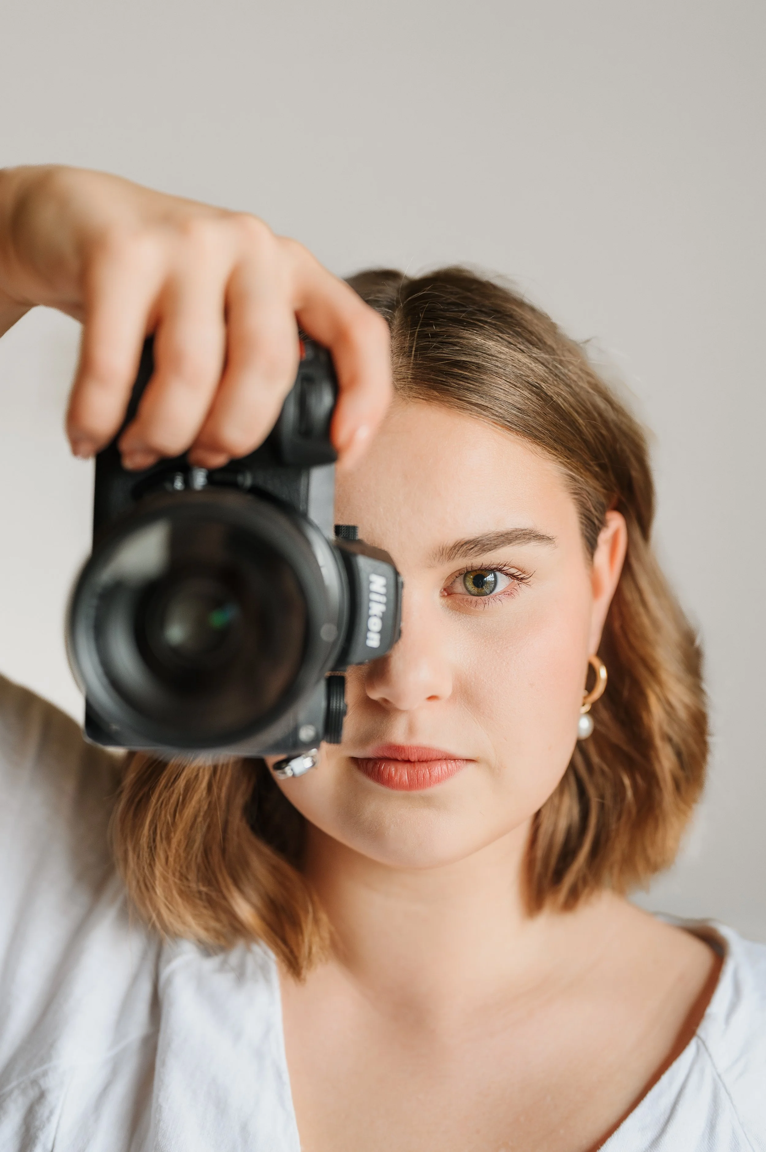 Photographer holding camera during creative branding portrait session