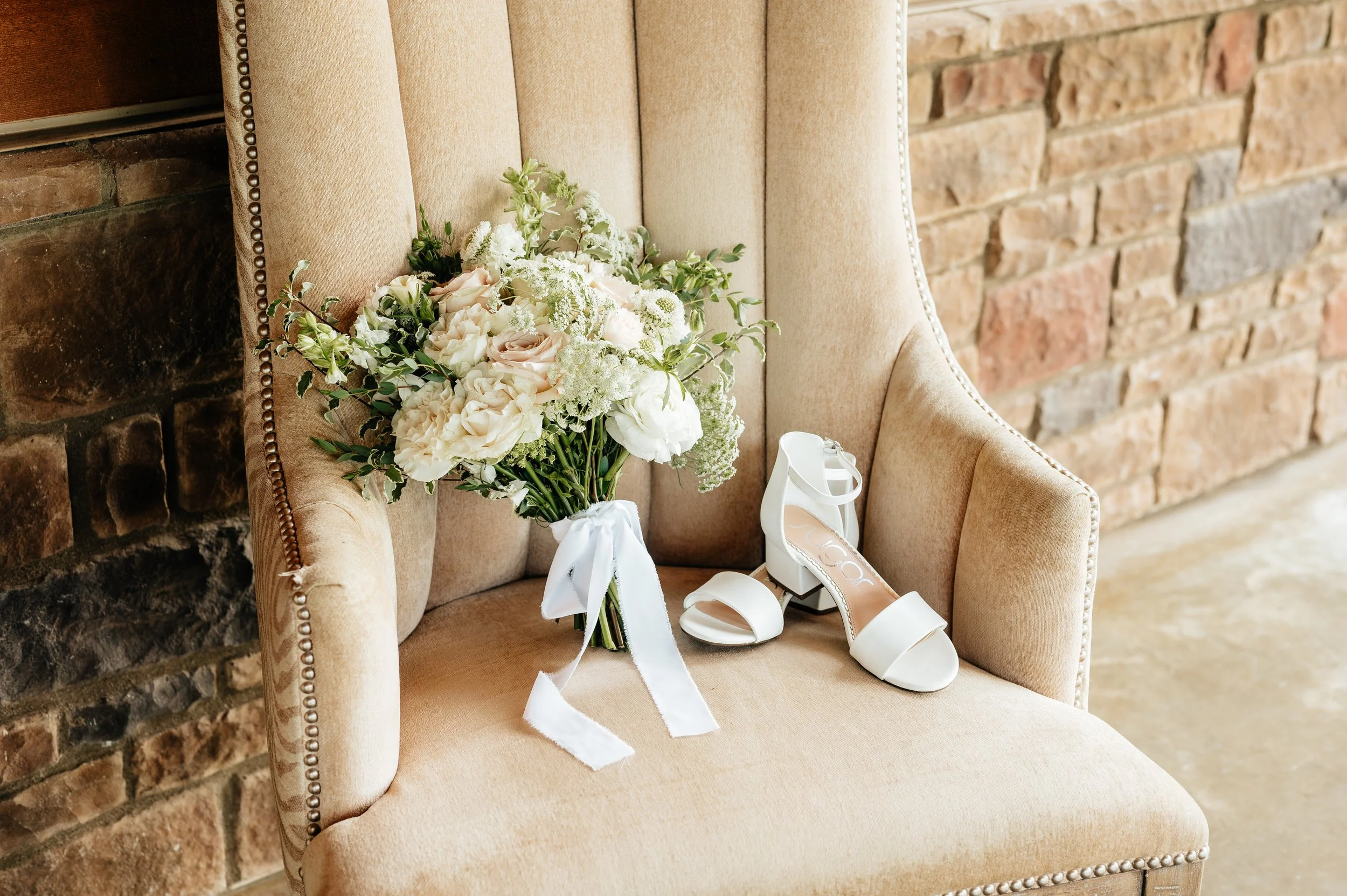 Wedding shoes and bridal bouquet styled for wedding flat lay