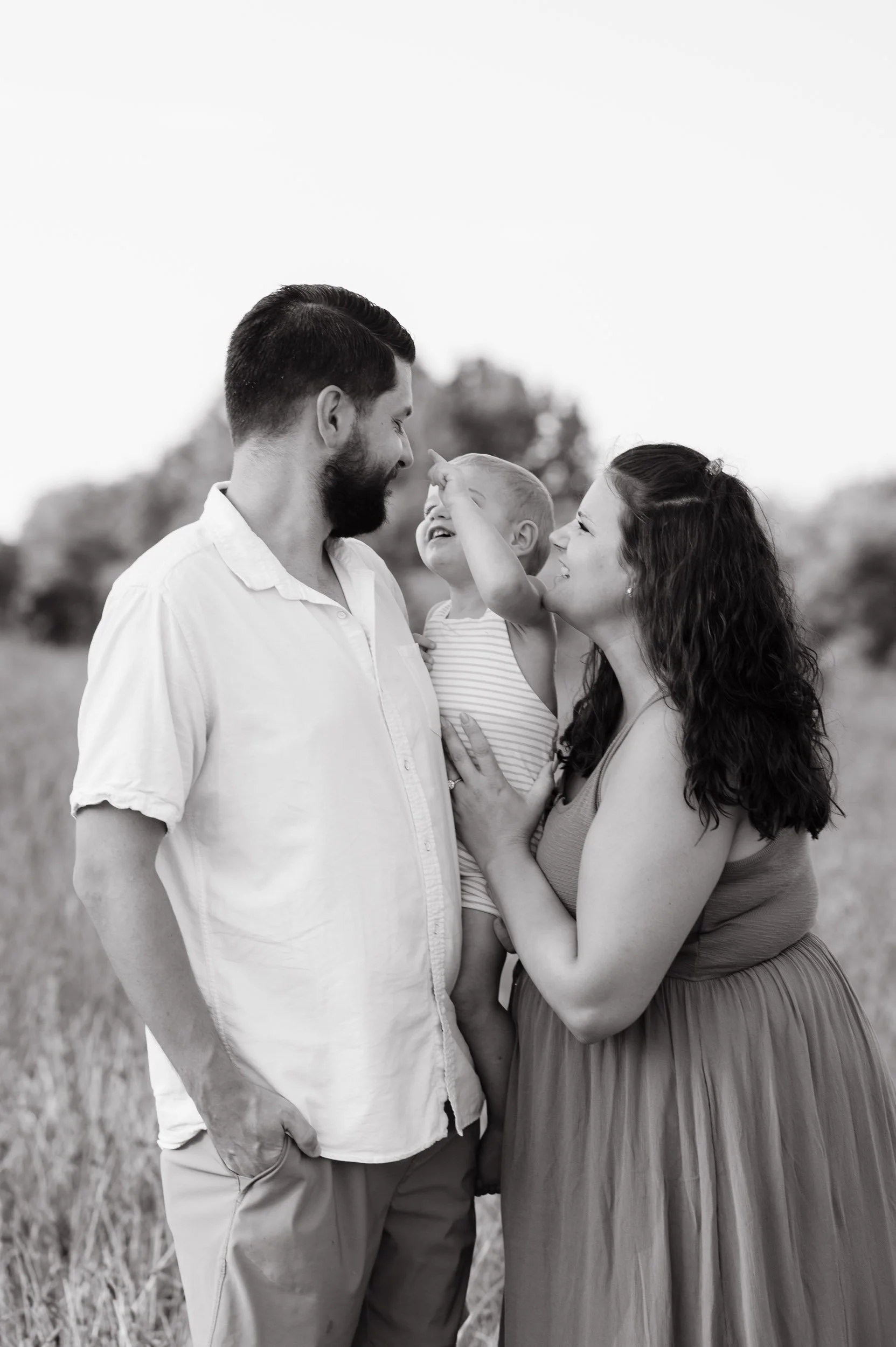 Black and white family playing together photographed outdoors