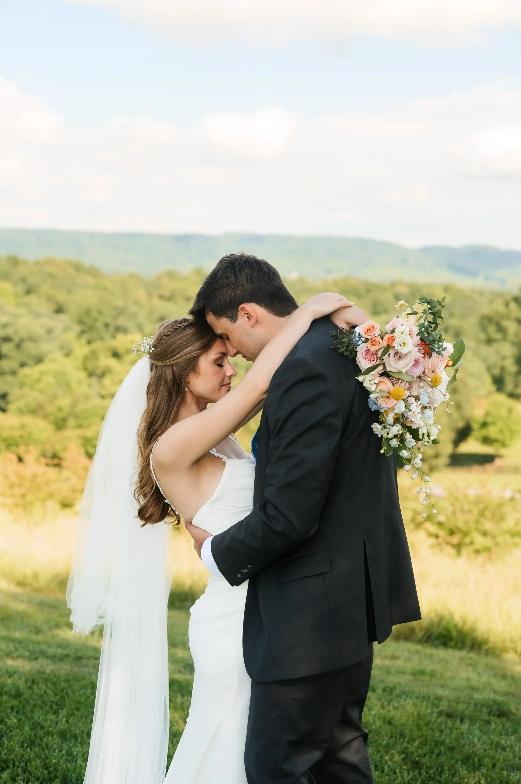 Bride and groom embracing outdoors with mountain views in Chattanooga Tennessee