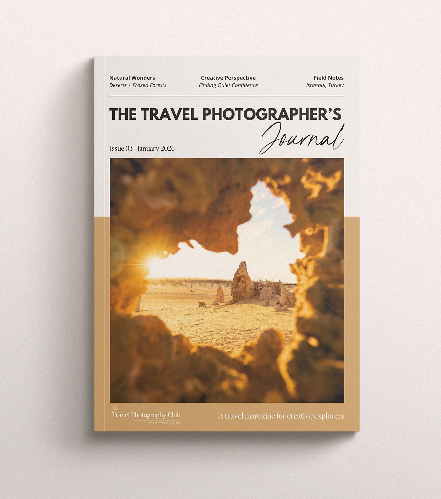 Travel magazine titled 'The Travel Photographer's Journal' with a cover photo of a desert landscape framed by a large rock with the setting sun in the background.