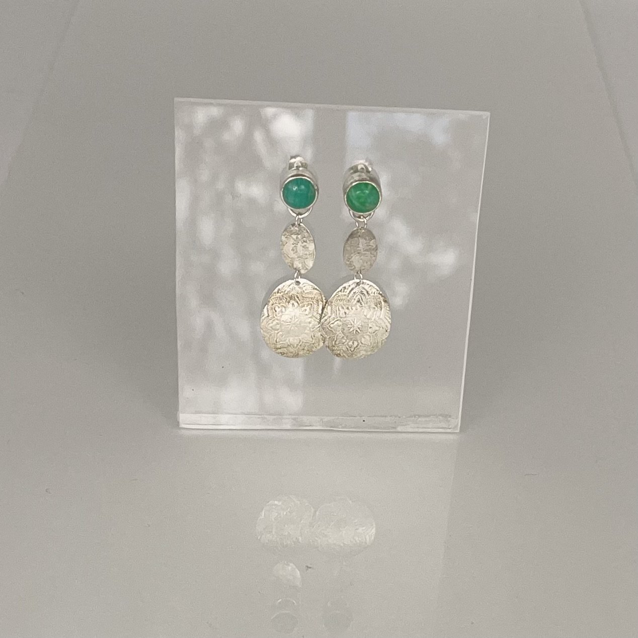 Amazonite gems with silver embossed textured pendants. Sterling silver stud style earrings
