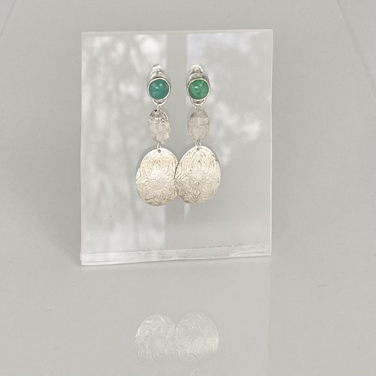 Amazonite gems with silver embossed textured pendants. Sterling silver stud style earrings