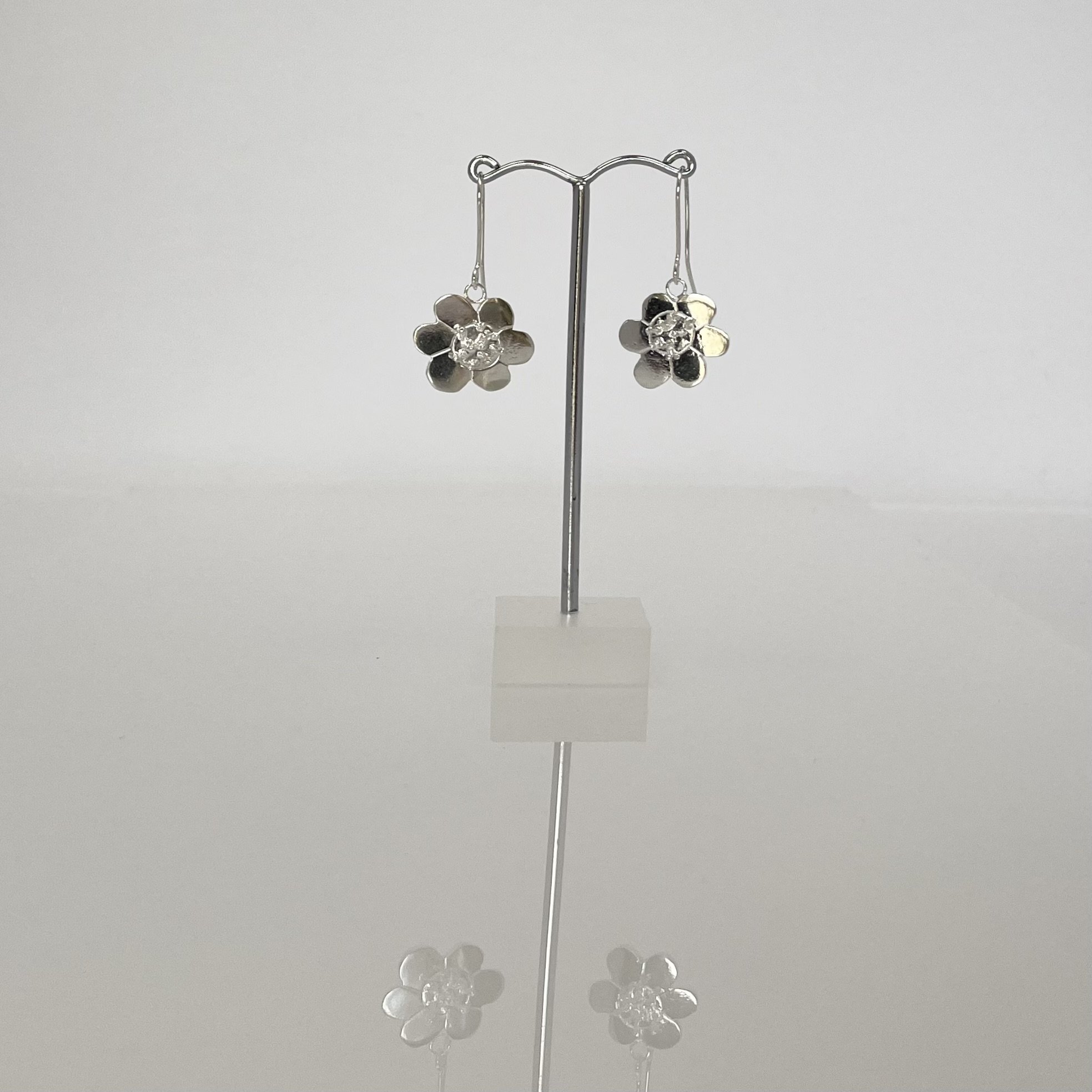 Solid sterling silver flower design earrings. Drop style earrings