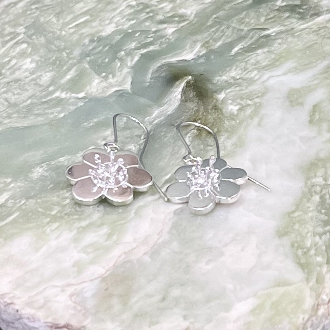Solid sterling silver flower design earrings. Drop style earrings