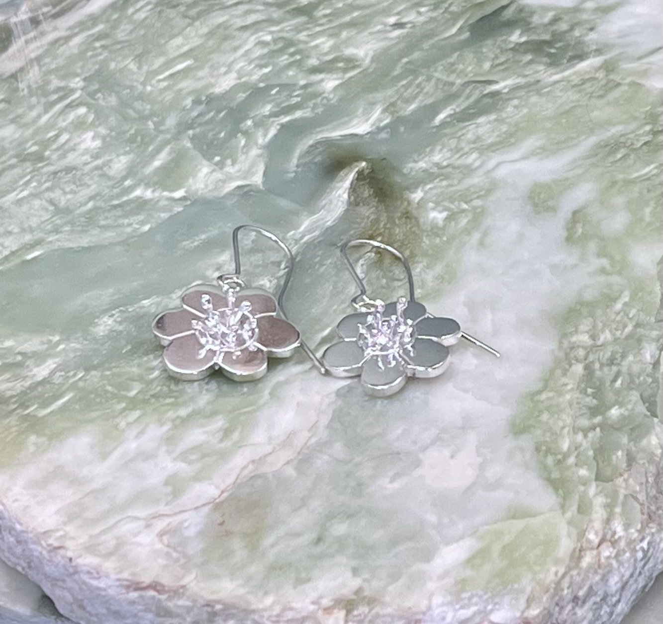 Solid sterling silver flower design earrings. Drop style earrings