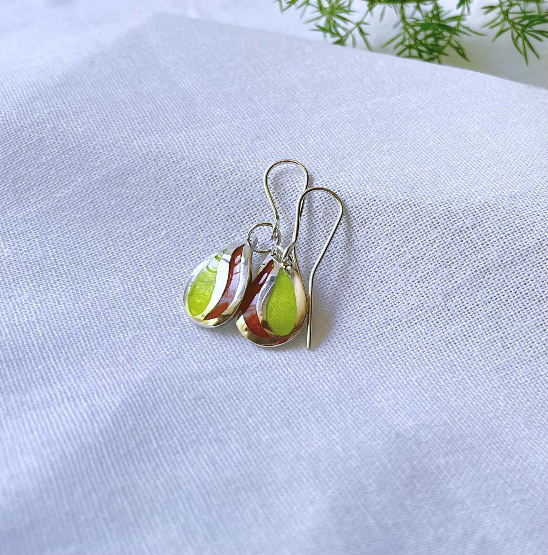 Sterling silver teardrop shaped earrings with citrus colour enamels. Drop style earrings